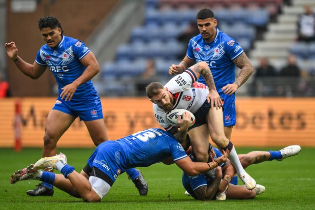 Daryl Clark of England breaks the tackle of Jeremiah Nanai and Jazz Tevaga of Samoa  during the ABK Beer Internationals Series match England vs Samoa at The Brick Community Stadium, Wigan, United Kingdom, 27th October 2024

(Photo by Craig Thomas/News Images)
