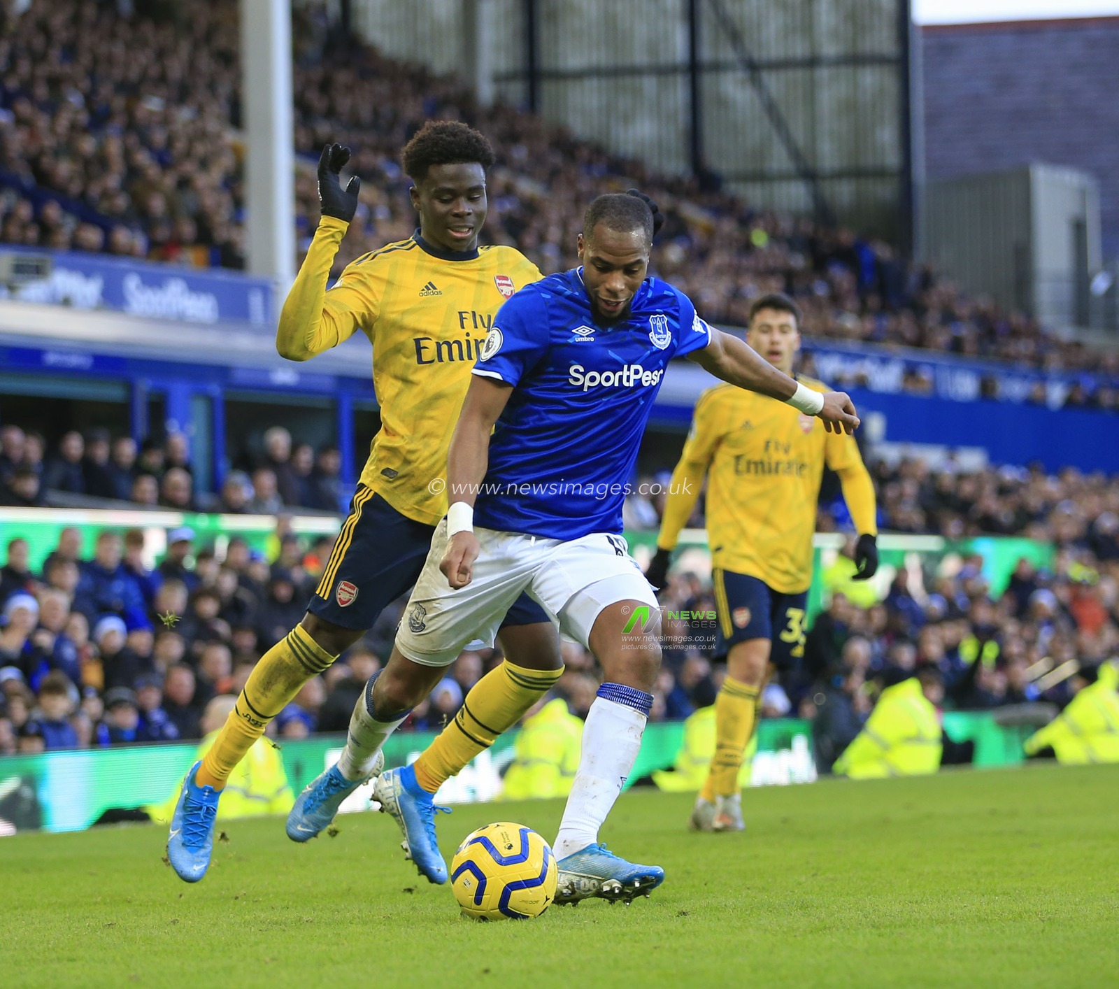 21st December 2019, Goodison Park, Liverpool, England; Premier League, Everton v Arsenal : Djibril Sidibe (19) of Everton crosses the ball under challenge from Bukayo Saka (77) of Arsenal

Credit: Conor Molloy/News Images