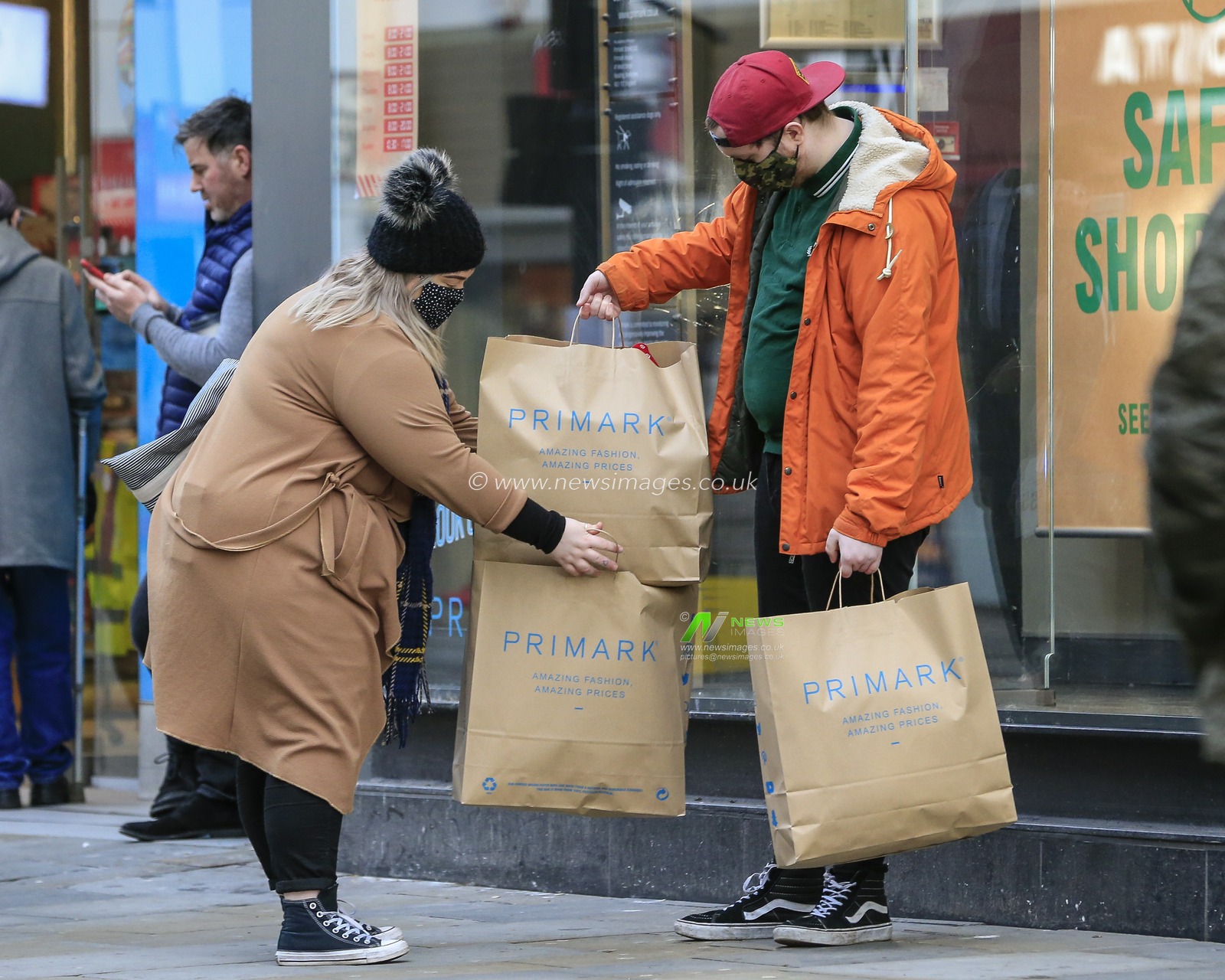 Christmas shoppers with their bags from Primark in Northumberland Street, Newcastle upon Tyne after stores reopen after the end of the country's second national lockdown