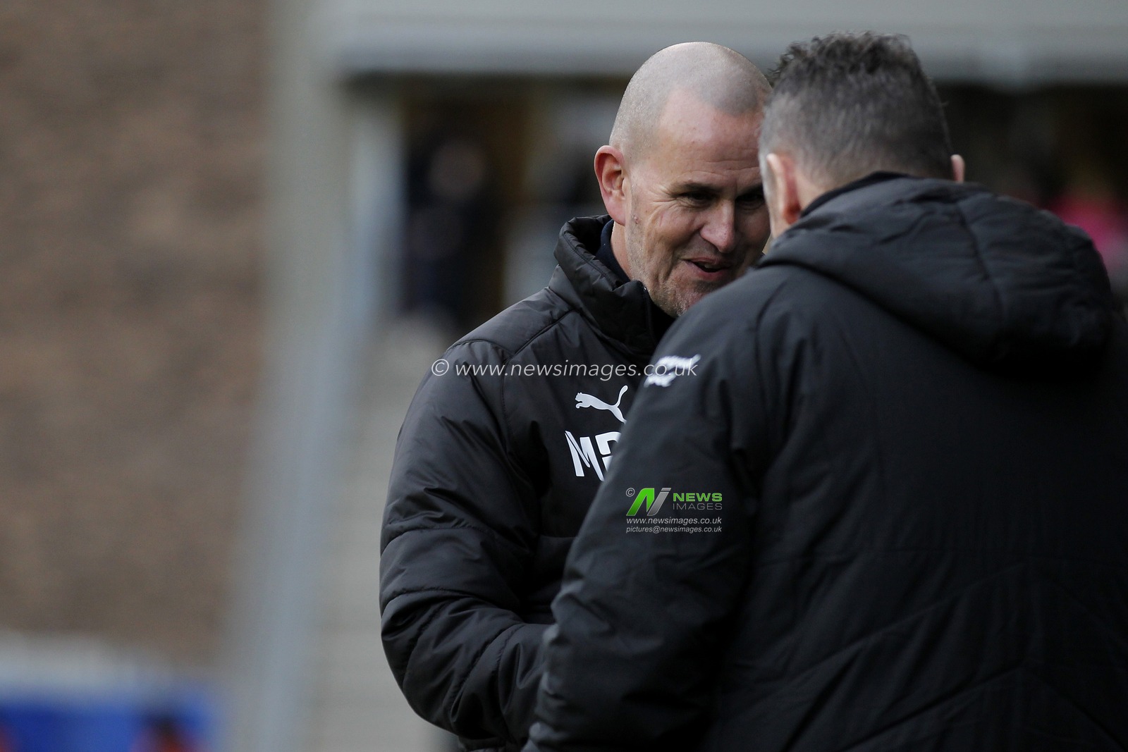 Mark Robinson manager of AFC Wimbledon greeting Steve Cotterill manager of Shrewsbury Town