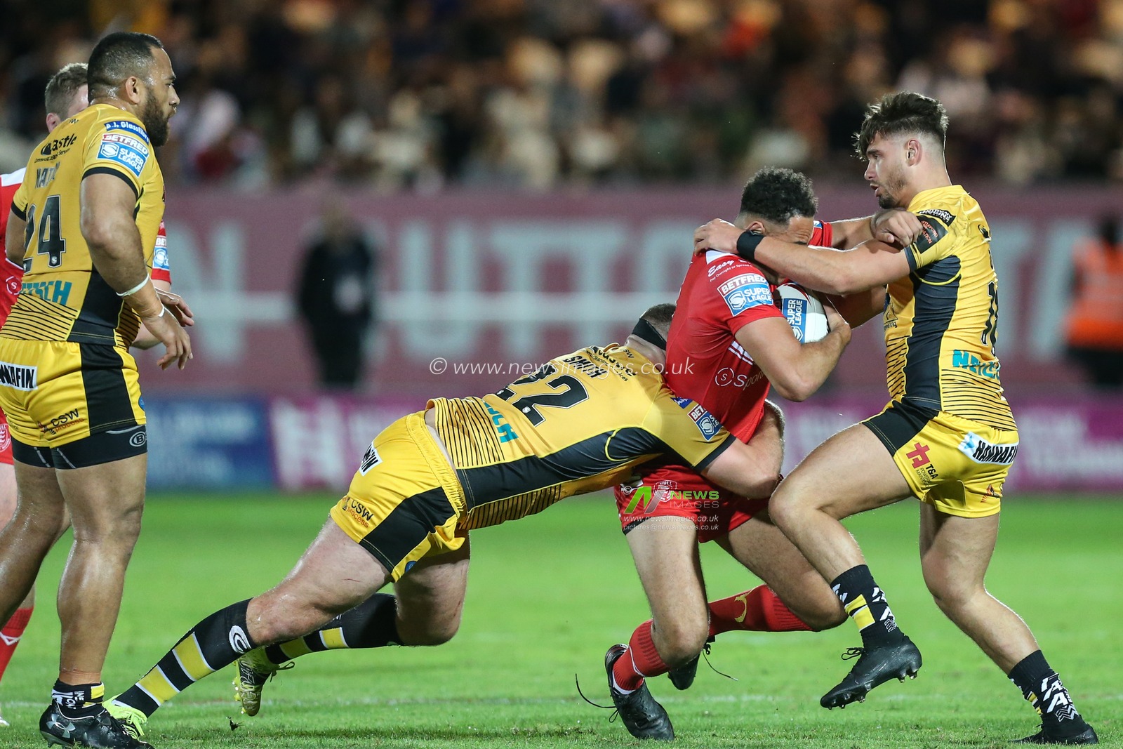 Luis Johnson (27) of Hull KR is tackled by Daniel Smith (22) of Castleford Tigers