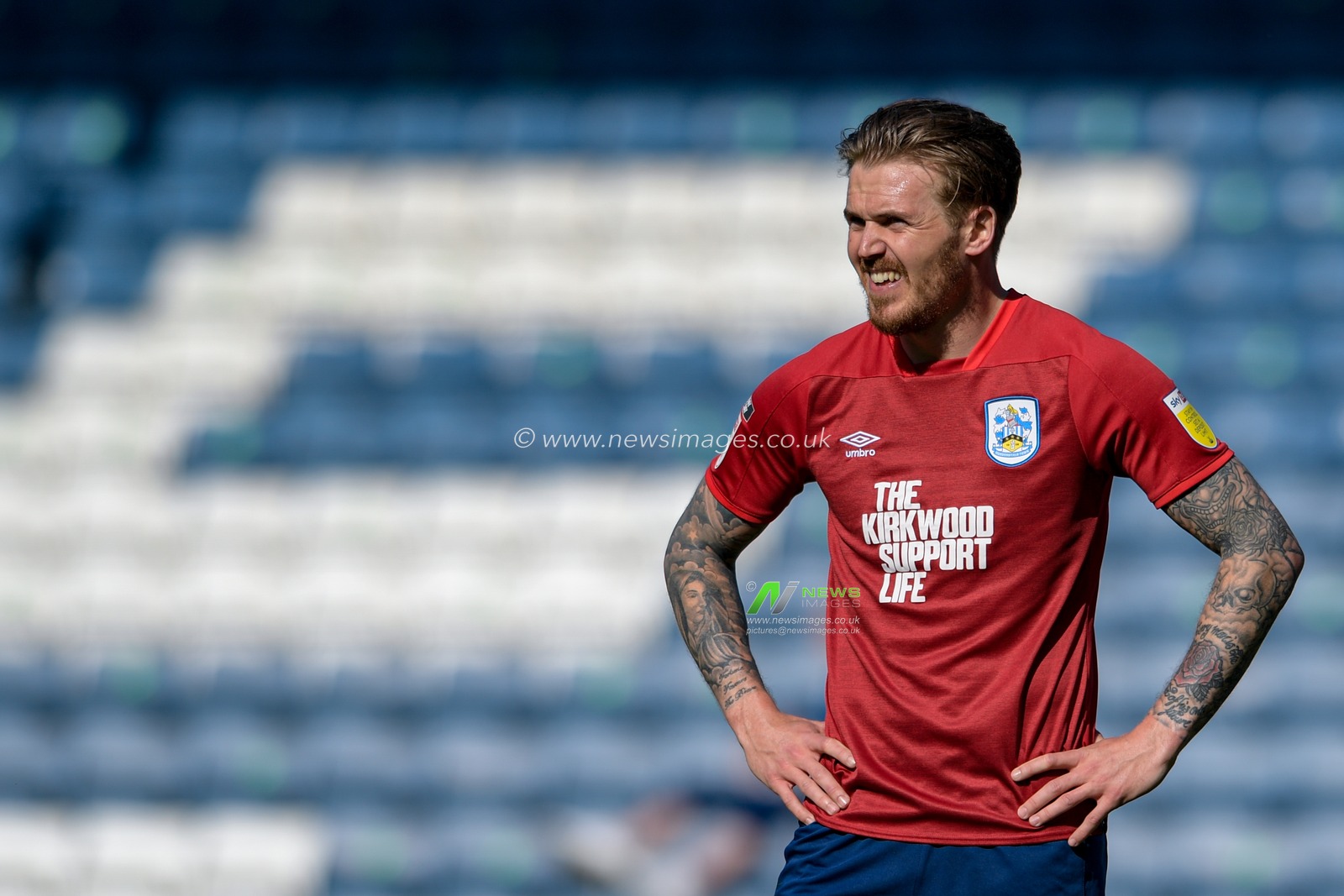 Danny Ward #25 of Huddersfield Town stands with his hands on his hips