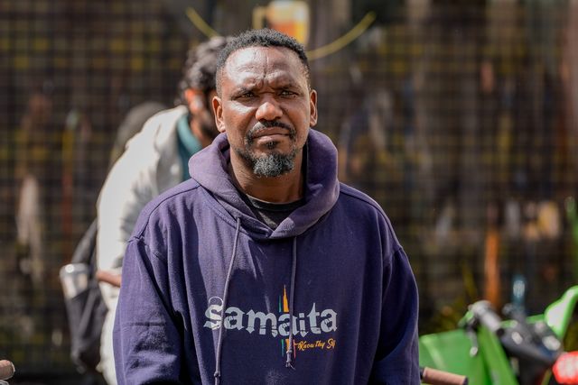 Blessed Mhlanga, a journalist imprisoned for 73 days and a guest at UN Watch recently looks on as Zimbabweans protest against the proposed constitution amendment at Embassy of Zimbabwe, London, United Kingdom on 18 April 2026

(Photo by Maynard Manyowa/News Images)