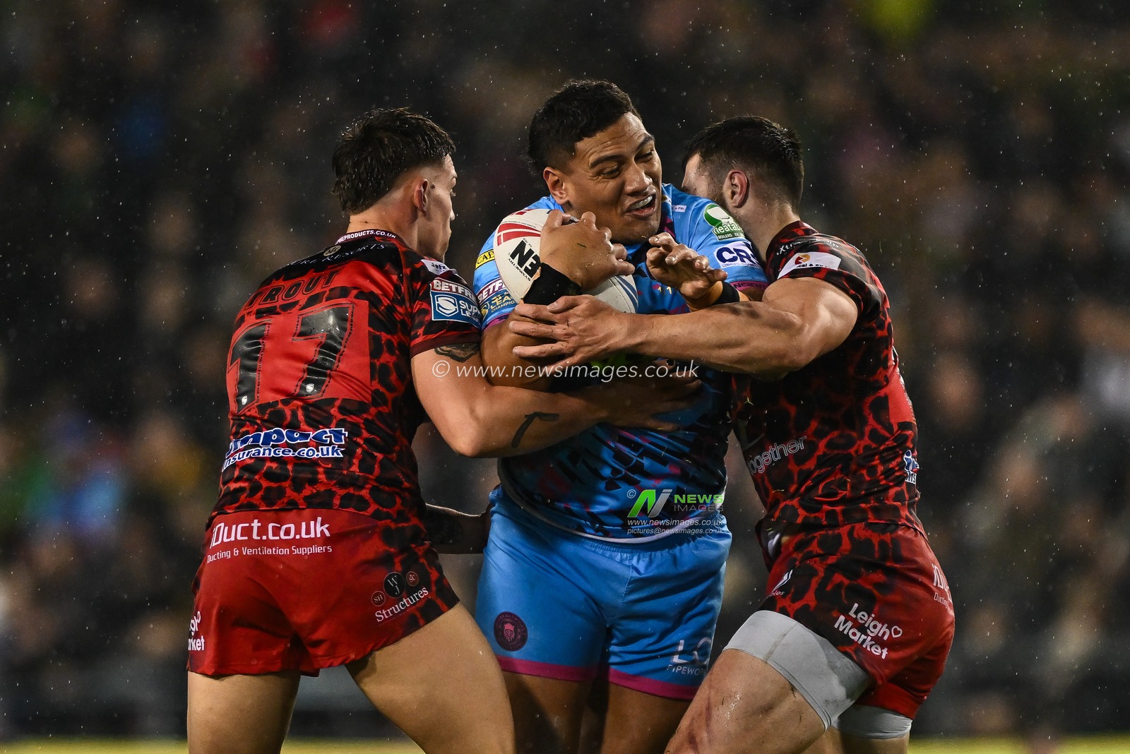 Patrick Mago of Wigan Warriors is tackled by Owen Trout of Leigh Leopards and Frankie Halton of Leigh Leopards during the Betfred Super League Round 7 match Leigh Leopards vs Wigan Warriors at Leigh Sports Village, Leigh, United Kingdom, 4th April 2024

(Photo by Craig Thomas/News Images)