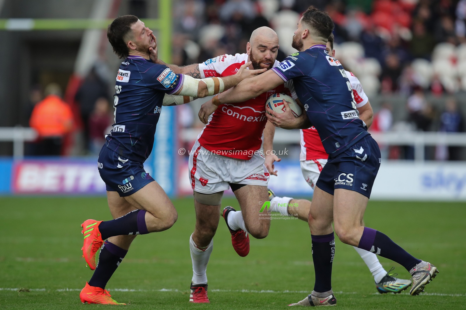 Toby King and Cade Cust #6 of Wigan Warriors tackle Kane Linnett #12 of Hull KR during the Betfred Super League Round 1 match Hull KR vs Wigan Warriors at Sewell Group Craven Park, Kingston upon Hull, United Kingdom, 18th February 2023

(Photo by James Heaton/News Images)