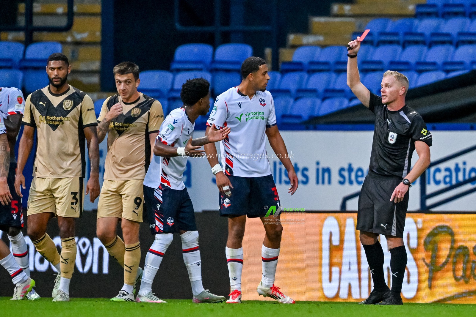 Referee Andrew Humphries shows Thierry Gale of Bolton Wanderers  a straight red card after a challenge during the The Vertu Trophy match Bolton Wanderers vs Rotherham United at Toughsheet Community Stadium, Bolton, United Kingdom, 2nd September 2025

(Photo by Adam Gee/News Images)