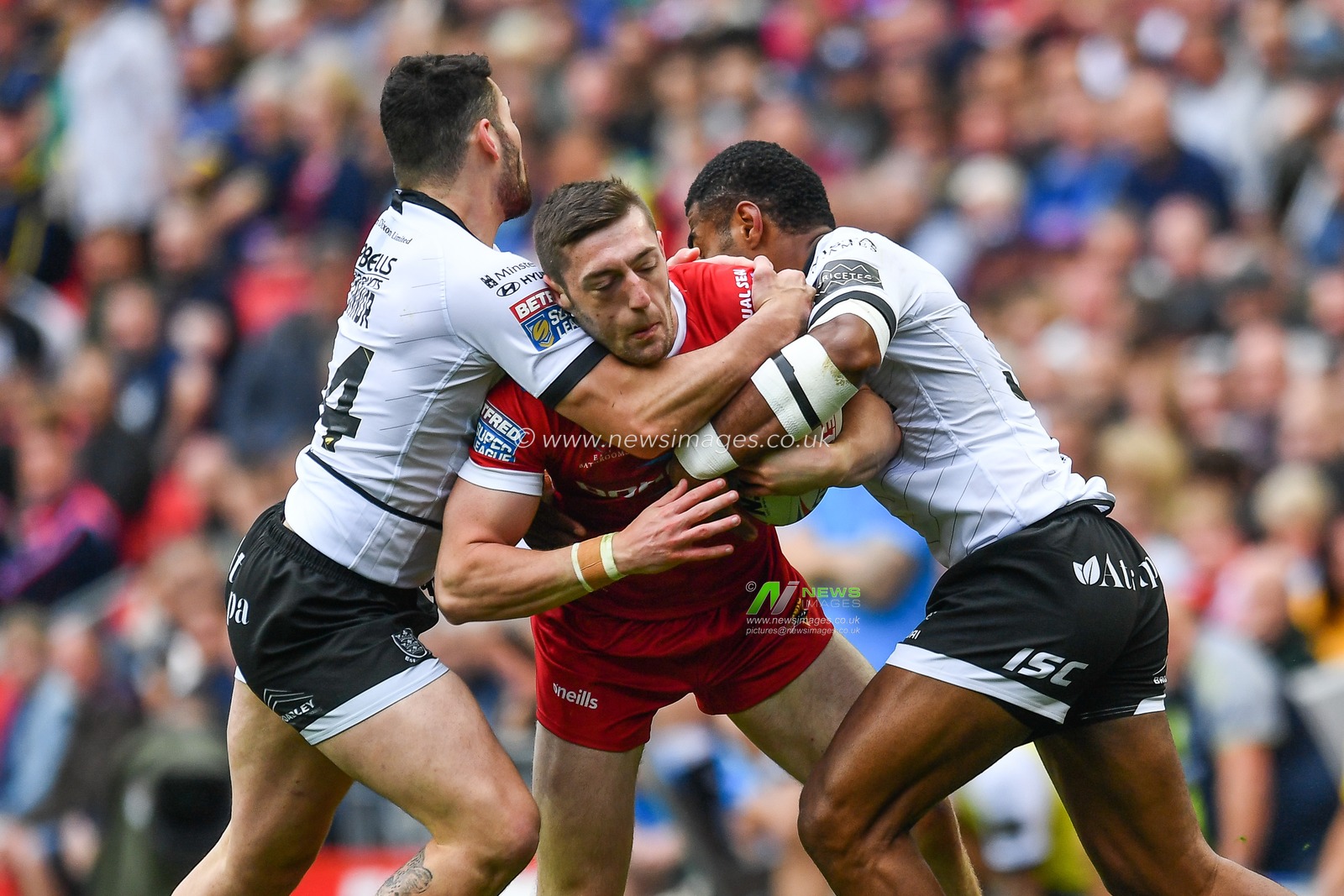25th May 2019 , Anfield Stadium, Liverpool, England; Dacia Magic Weekend, Betfred Super League Round 16, Hull FC vs Huddersfield Giants ; Jake Wardle (20) of Huddersfield Giants is tackled by Josh Griffin (4) of Hull FC 

Credit: Craig Thomas/News Images