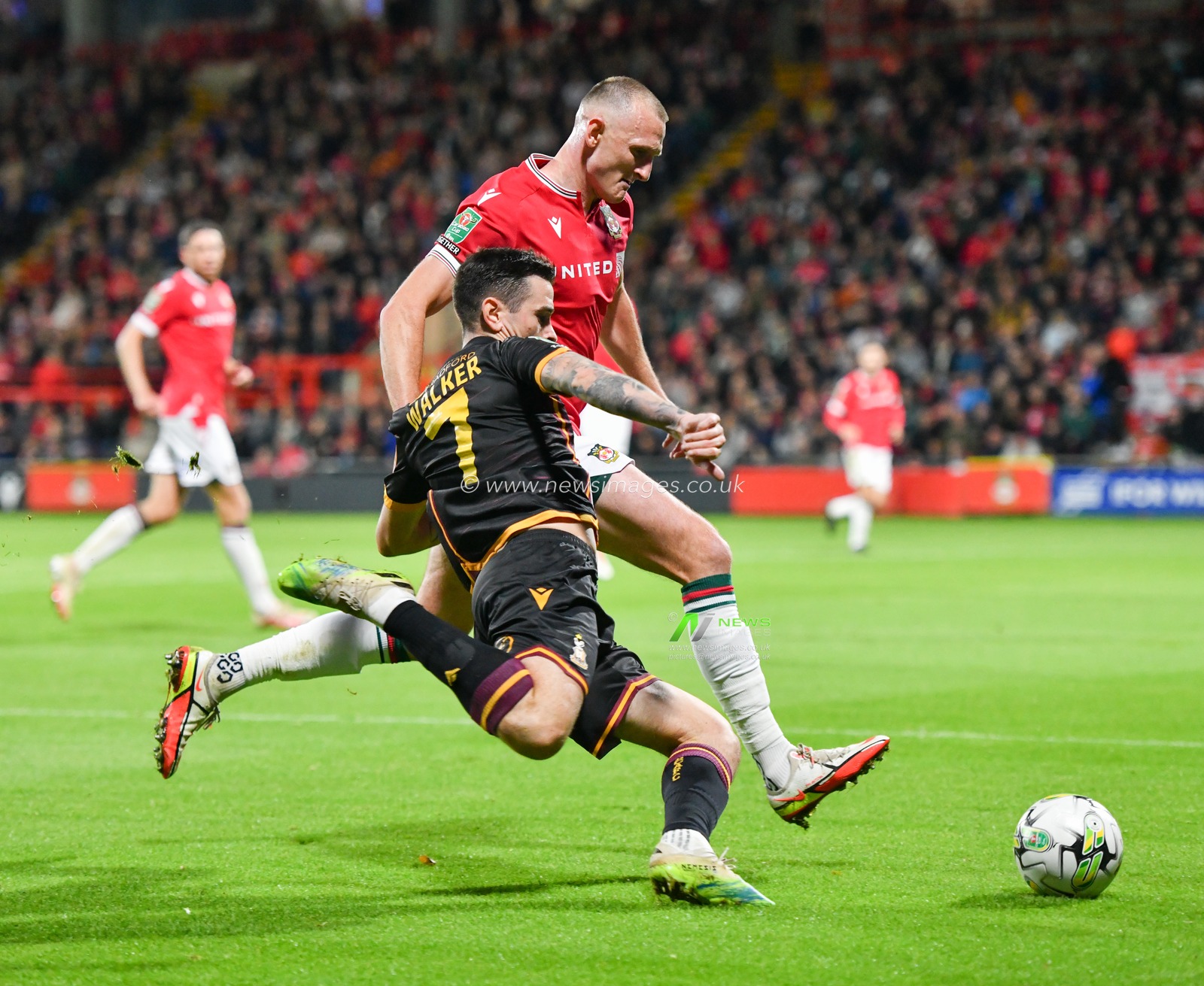 Bradfordâ€™s Jamie Walker crosses the ball into the box while being chased down by Wrexham's William Boyle, during the Carabao Cup match Wrexham vs Bradford City at The Racecourse Ground, Wrexham, United Kingdom, 29th August 2023

(Photo by Cody Froggatt/News Images)