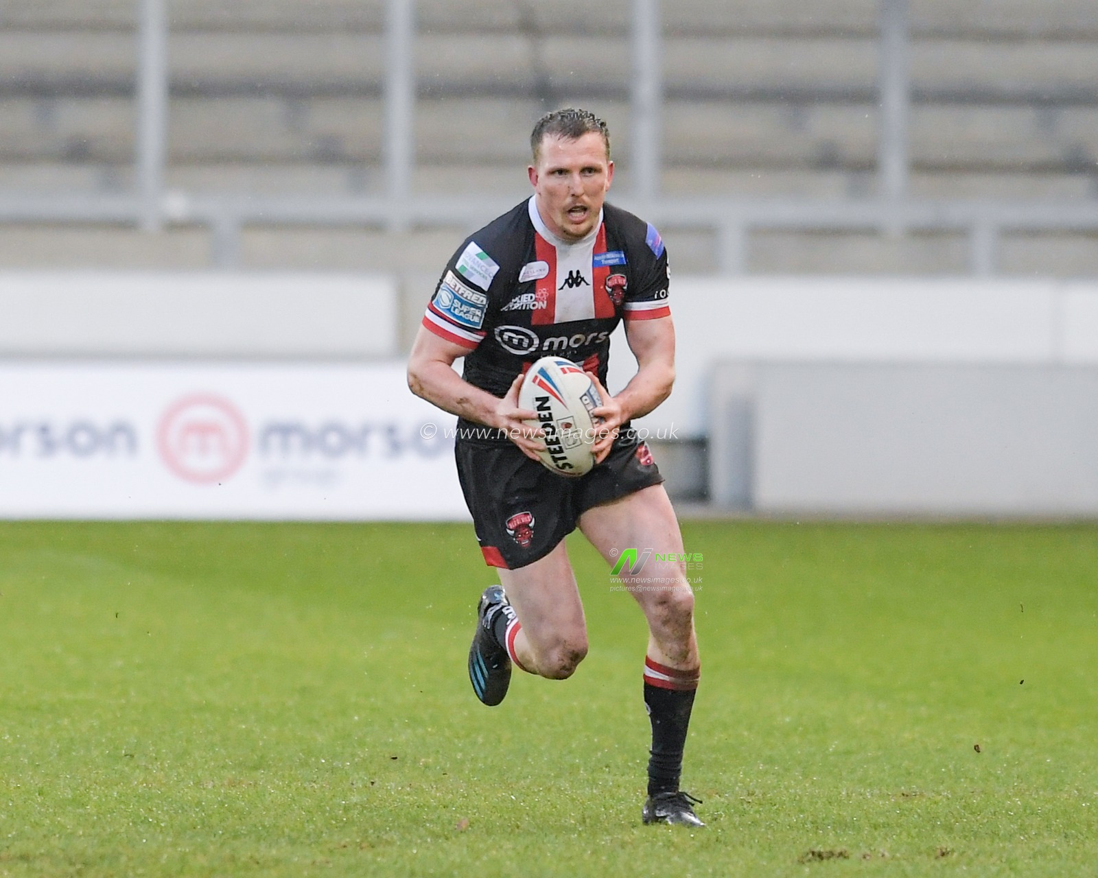 Dan Sarginson (23) of Salford Red Devils runs forward with the ball