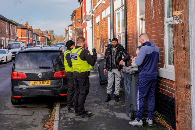 A police officer speaks to members of the public outside an address on Cambridge Street, Derby, during a Major Explosives Incident in Derby that began on Thursday December 4 when police executed a warrant at an address on Vulcan Street, Derby, that saw two men arrested on suspicion of explosives offences and 200 homes evacuated (Maynard Manyowa / News Images)