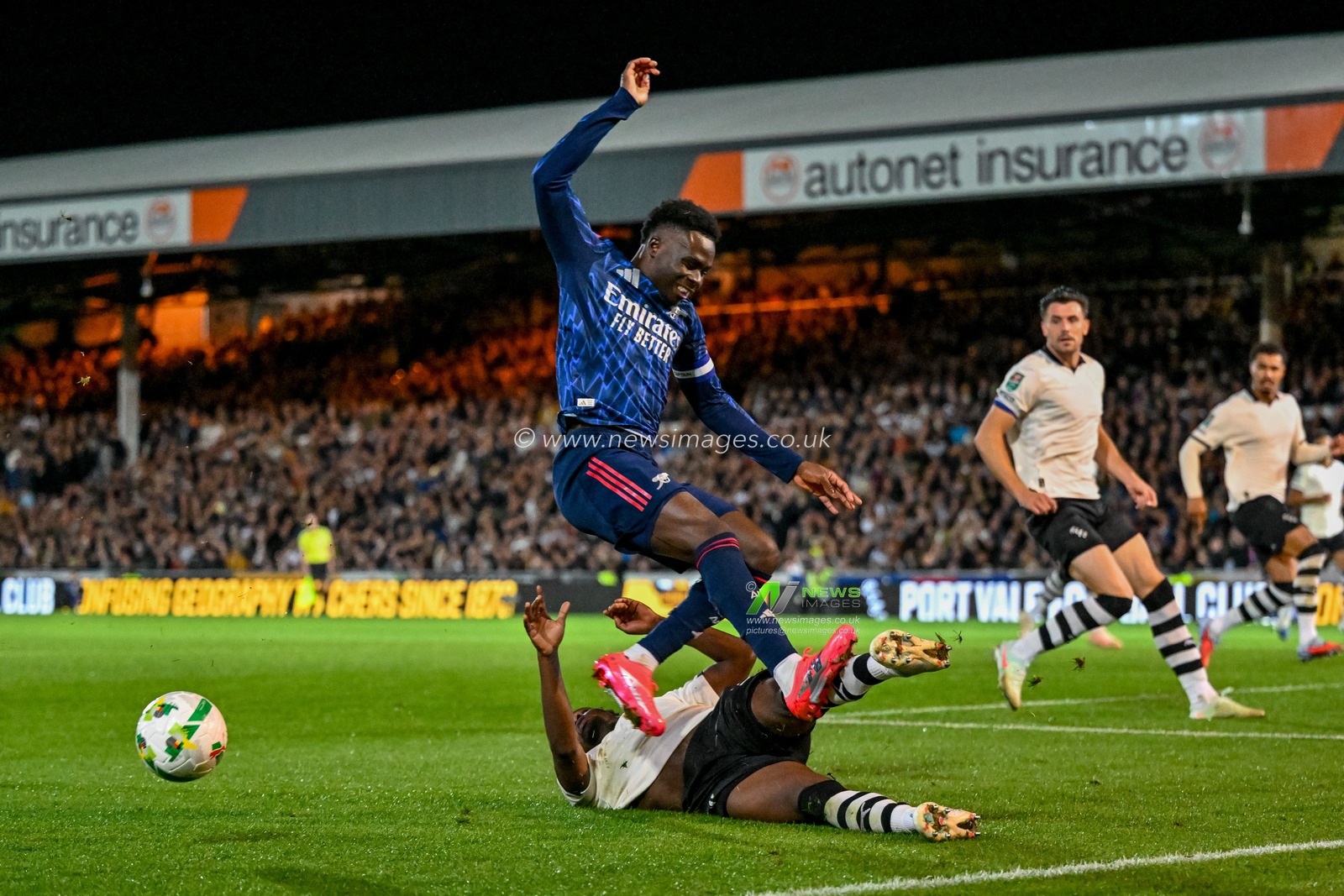 Bukayo Saka of Arsenal  is tackled in the Port Vale area by Jaheim Headley of Port Vale during the Carabao Cup Round 3 match Port Vale vs Arsenal at Vale Park, Burslem, United Kingdom, 24th September 2025

(Photo by Adam Gee/News Images)