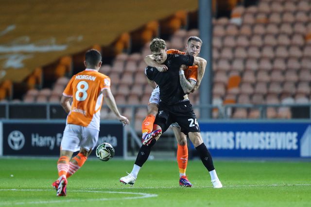Michael Smith of Sheffield Wednesday holds off Oliver Casey of Blackpool during the Carabao Cup match Blackpool vs Sheffield Wednesday at Bloomfield Road, Blackpool, United Kingdom, 17th September 2024

(Photo by Gareth Evans/News Images)