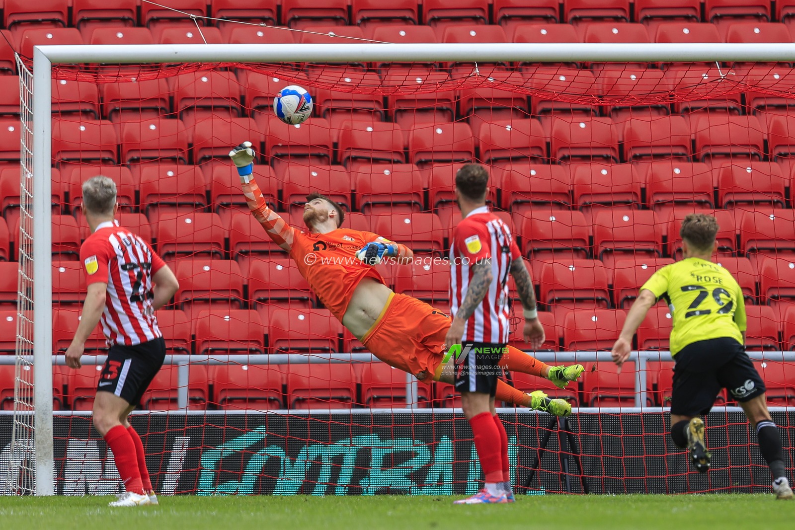 Lee Burge #1 of Sunderland tries to save a shot from Sam Hoskins #7 of Northampton Town, but he scores from a free-kick just outside of the Sunderland penalty area to make it 0-1