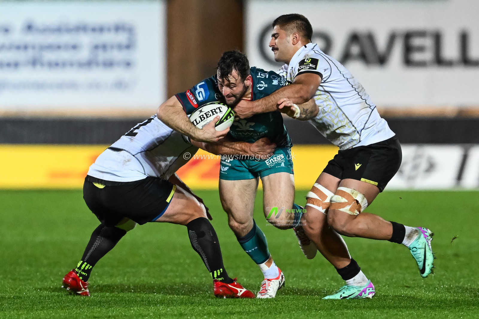 Ryan Conbeer of Scarlets is tackled by Beka Mamrikashvili and Luka Ivanishvili of Black Lion  during the European Rugby Challenge Cup match Llanelli Scarlets vs Black Lion at Parc y Scarlets, Llanelli, United Kingdom, 15th December 2023

(Photo by Craig Thomas/News Images)