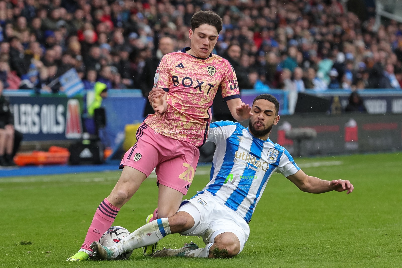 Brodie Spencer of Huddersfield Town with a successful tackle on Daniel James of Leeds United during the Sky Bet Championship match Huddersfield Town vs Leeds United at John Smith's Stadium, Huddersfield, United Kingdom, 2nd March 2024

(Photo by James Heaton/News Images)