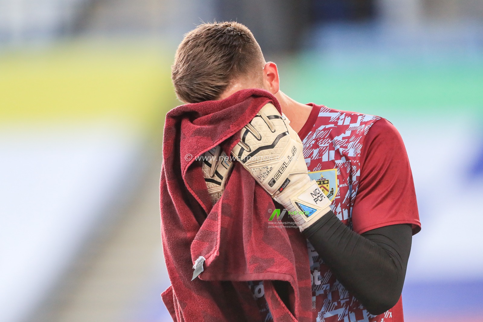 Nick Pope (1) of Burnley wipes is face during the pre-game warmup