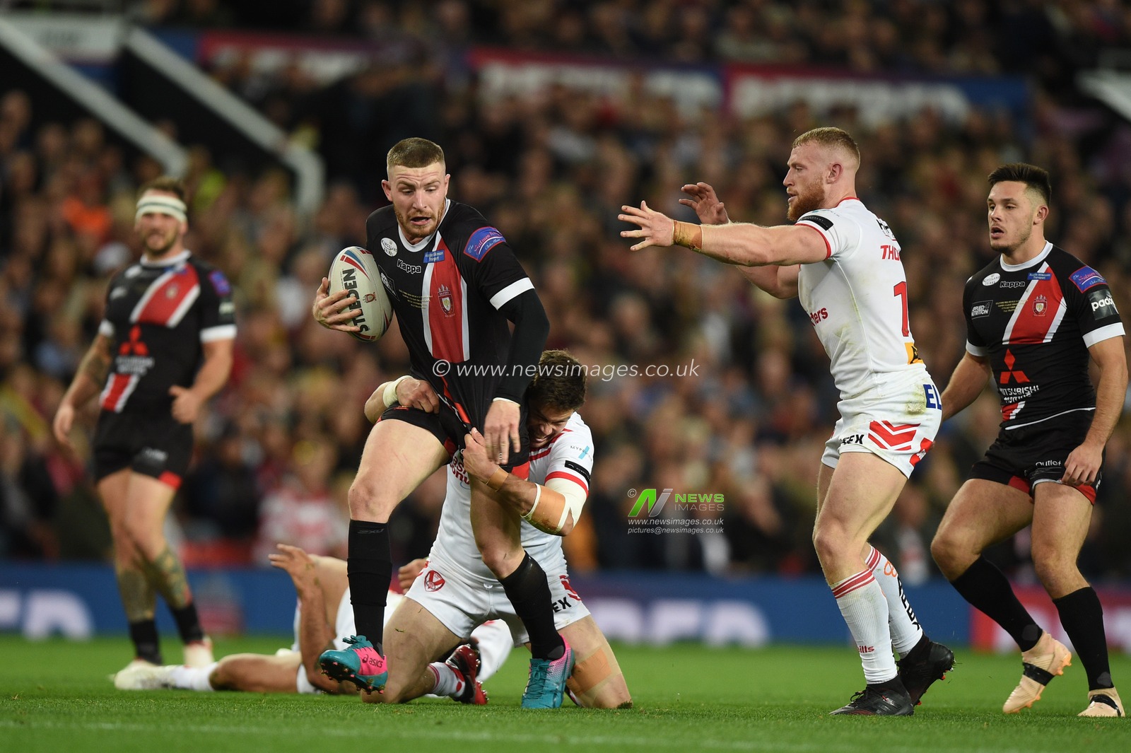 12th October 2019, Old Trafford, Manchester, England; The Grand Final 2019, Saint Helens v Salford Red Devils : Jackson Hastings (31) of Salford Red Devils is wrapped up by Louie McCarthy-Scarsbrook (13) of Saint Helens 

Credit: Richard Long/News Images