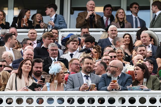 Racegoers look on as the 16:00 Randox Grand National Handicap Chase gets under way  during the Randox Grand National Day 2024 at Aintree Racecourse, Liverpool, United Kingdom, 13th April 2024

(Photo by Mark Cosgrove/News Images)