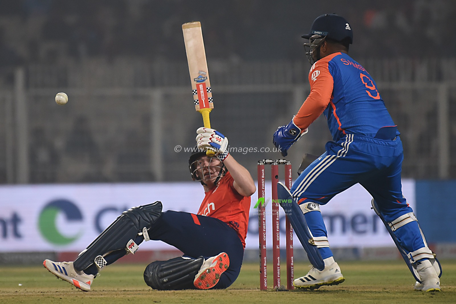 England's captain Jos Buttler falls on the ground in an attempt to play a shot on a delivery by India's Hardik Pandya, left, during the first T20 cricket match between India and England at Eden Gardens in Kolkata, India, Wednesday, Jan. 22, 2025.Pictures by Debajyoti Chakraborty.(Photo: Debajyoti Chakraborty/News Images)