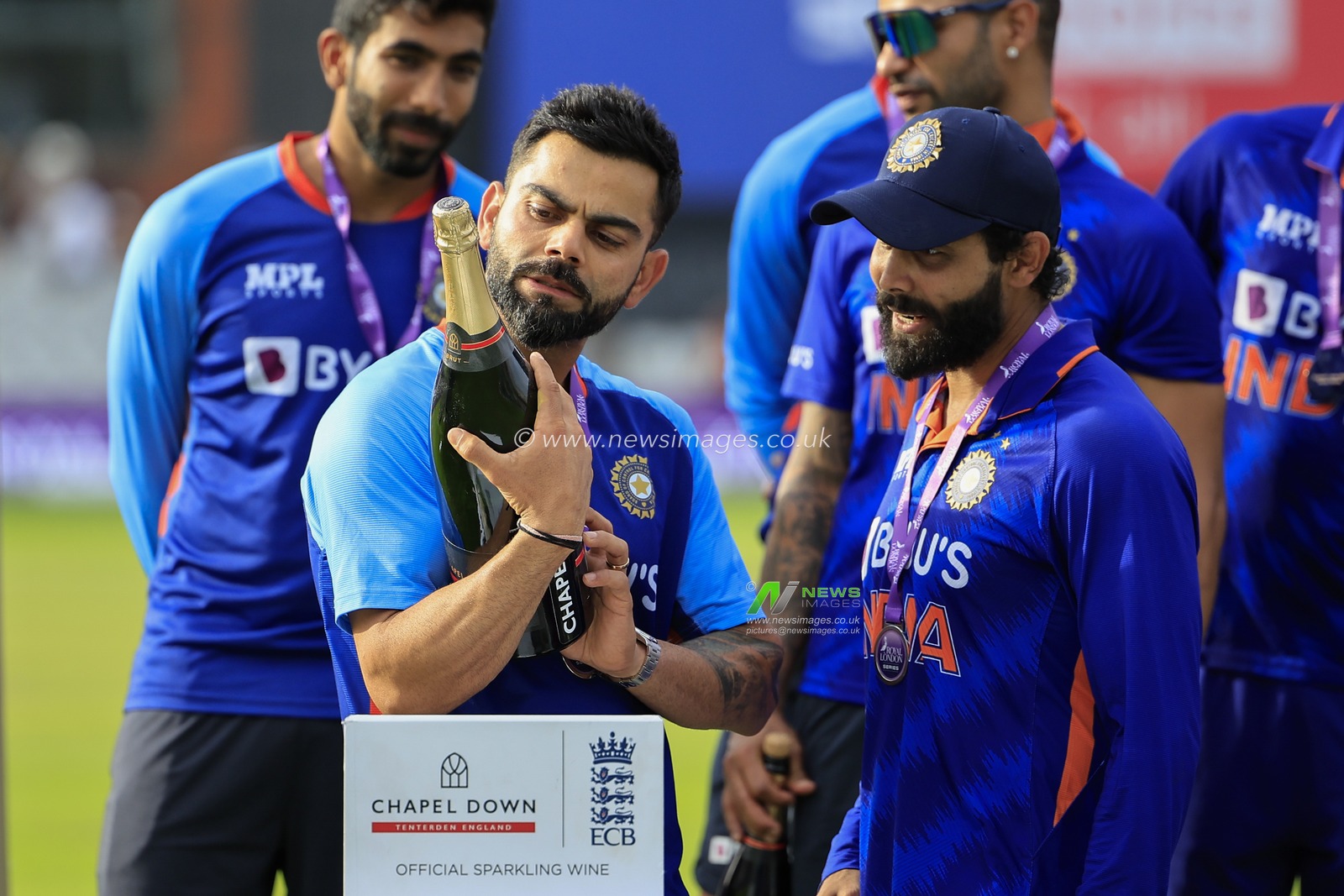 Virat Kohli of India checks out the celebratory champagne