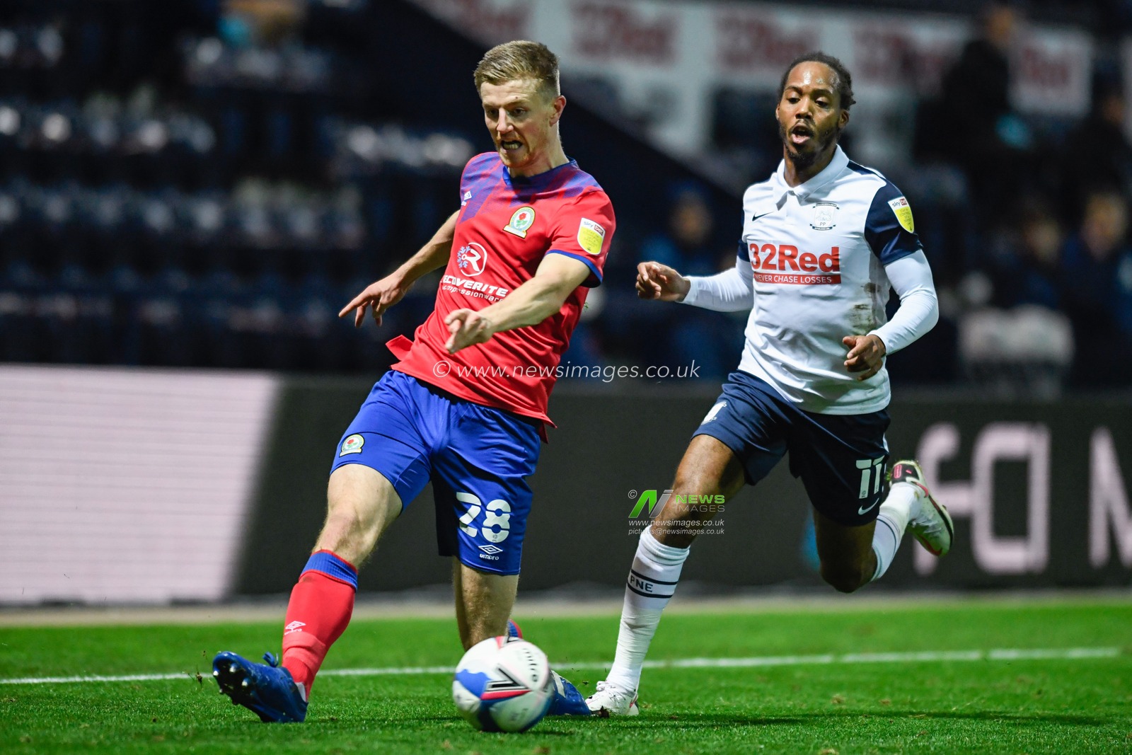 Scott Wharton #28 of Blackburn Rovers passes the ball under pressure from Daniel Johnson #11 of Preston North End