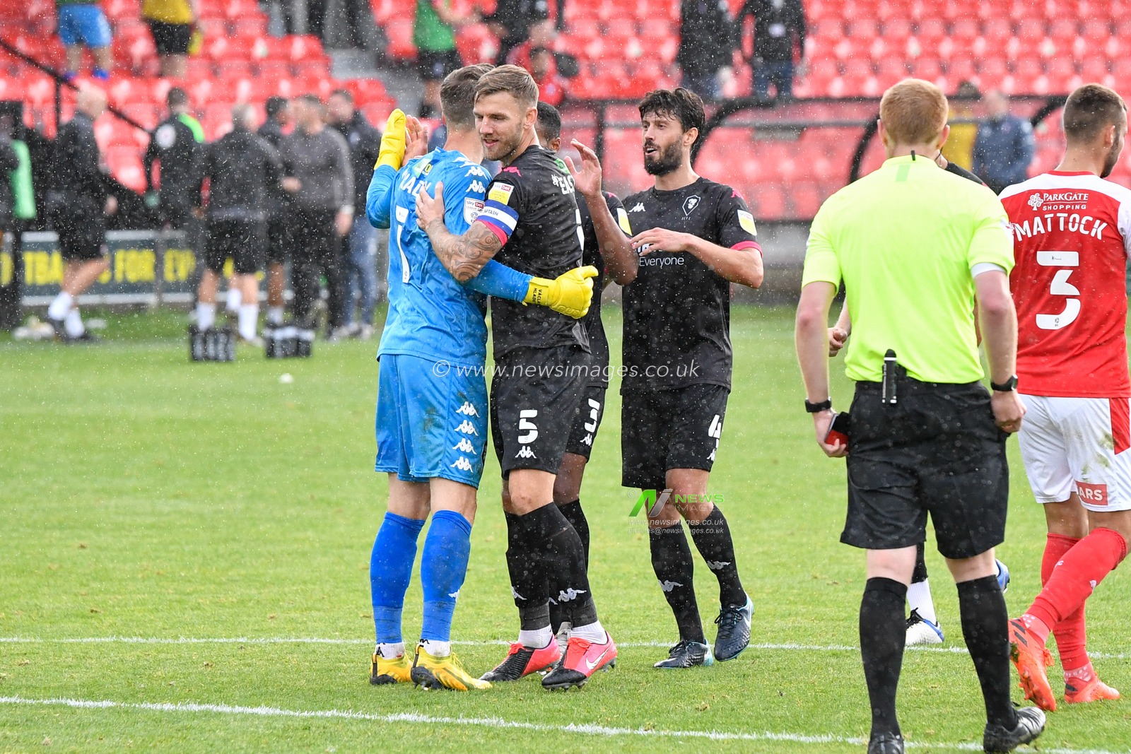 Ash Eastham (5) of Salford City hugs goalkeeper Vaclav Hladky (1) after he saves a penalty to put Salford City in the next round of the Carabao Cup