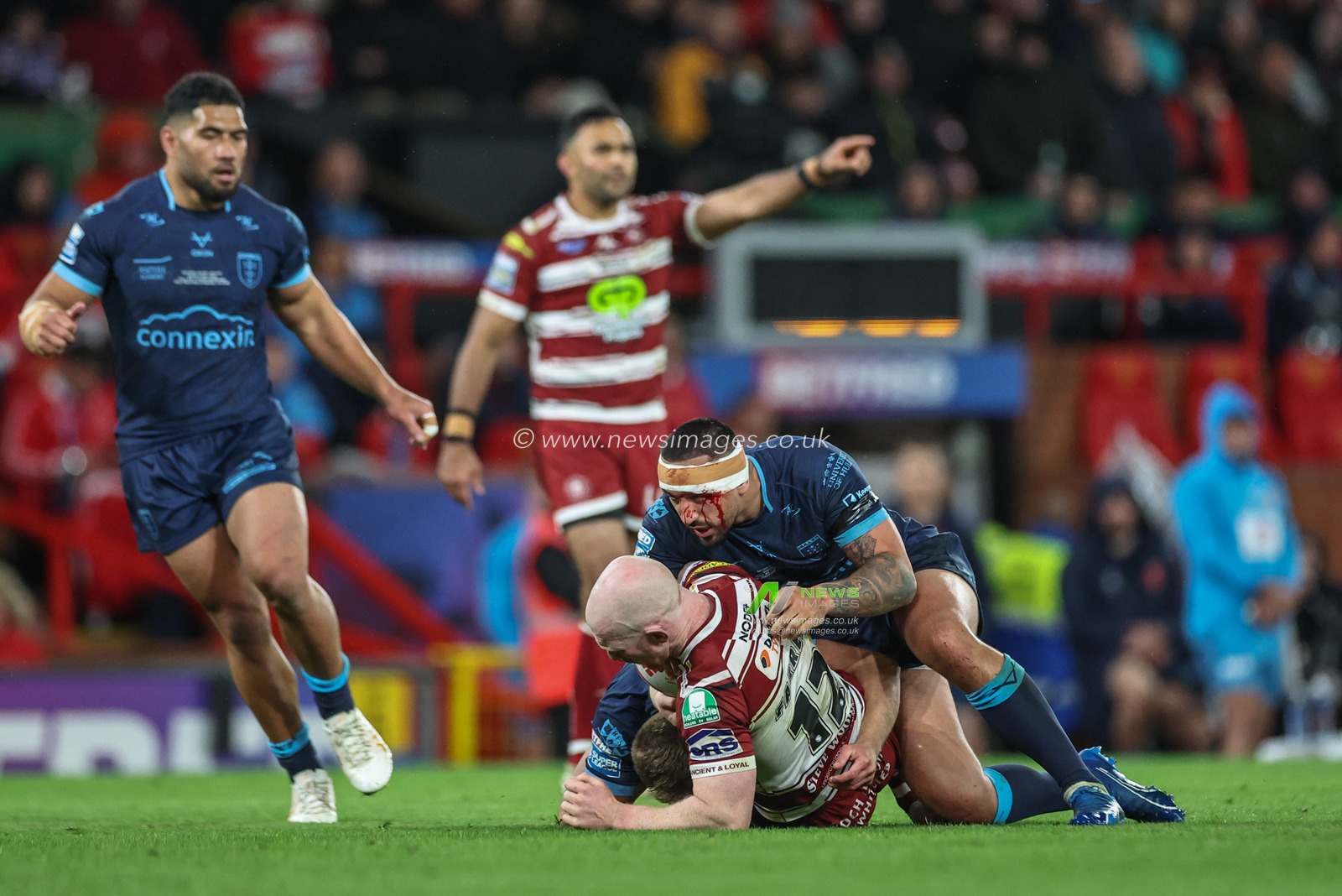 Liam Farrell of Wigan Warriors is tackled by Elliot Minchella of Hull KR during the Betfred Super League Grand Final match Wigan Warriors vs Hull KR at Old Trafford, Manchester, United Kingdom, 12th October 2024

(Photo by Mark Cosgrove/News Images)