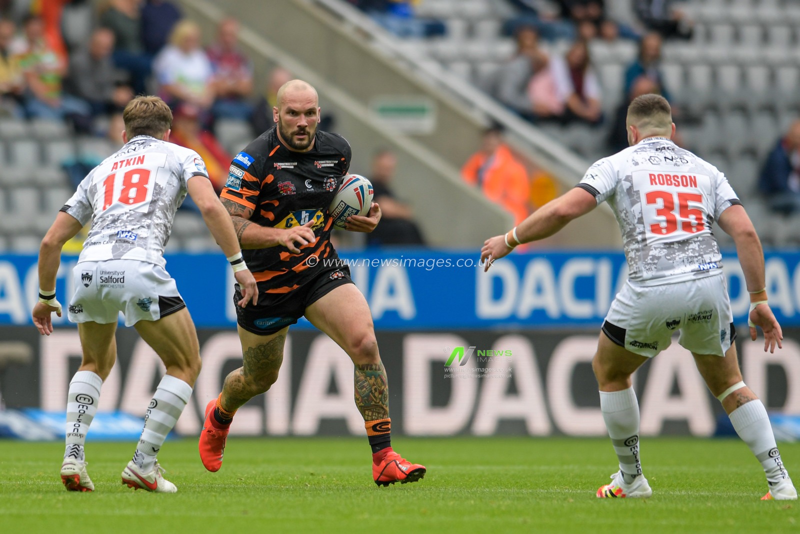 George Griffin (15) of Castleford Tigers runs forward with the ball