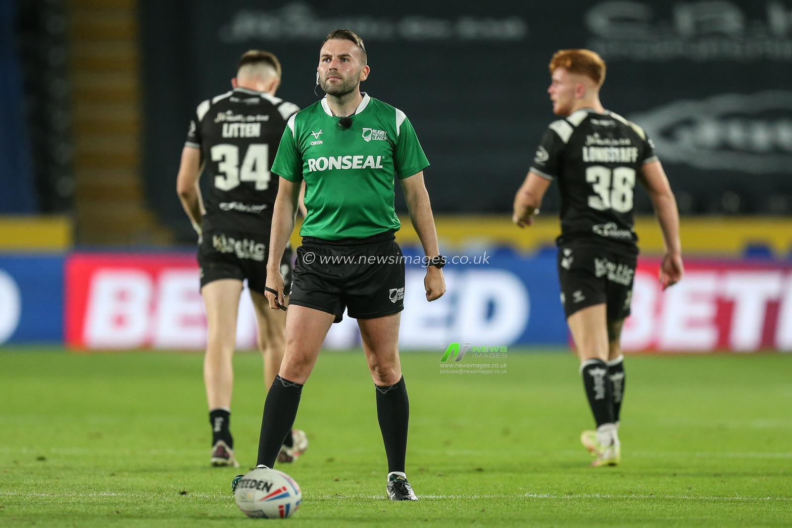 Referee Liam Moore looks towards the big screen