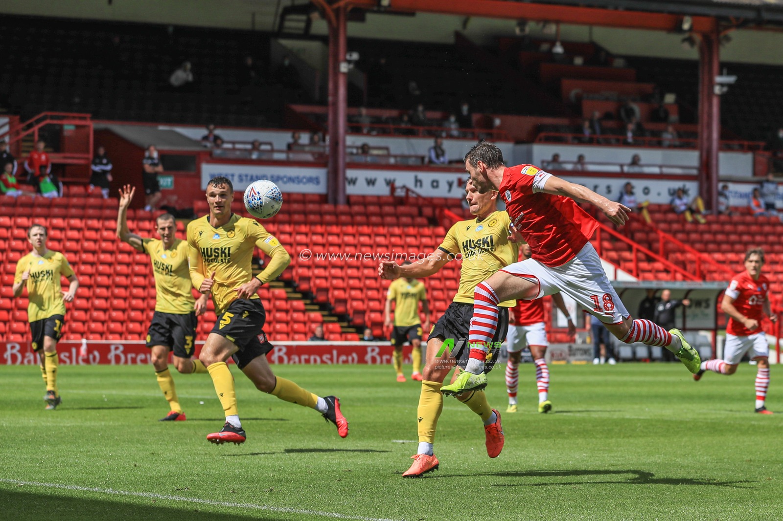 Michael Sollbauer (18) of Barnsley heads on goal