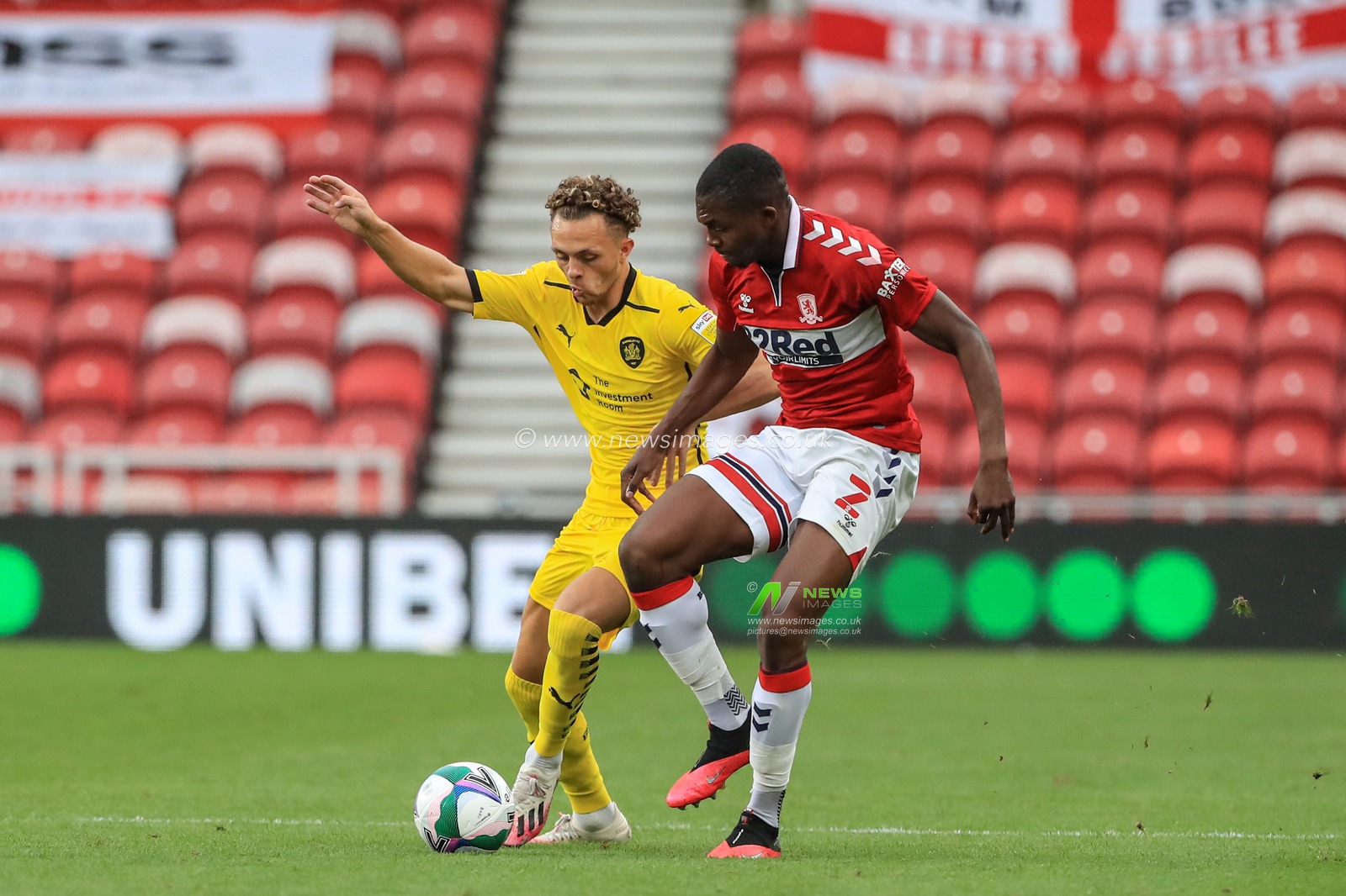 Jordan Williams (2) of Barnsley holds the ball as Anfernee Dijksteel (2) of Middlesbrough pressures