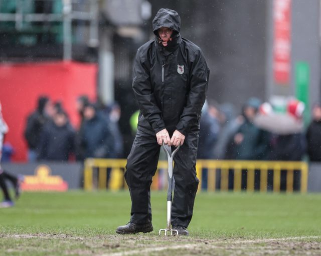 Ground staff fork the penalty area to rid the water during the Emirates FA Cup 4th Round match Grimsby Town vs Wolverhampton Wanderers at Blundell Park, Cleethorpes, United Kingdom on 15 February 2026

(Photo by Mark Cosgrove/News Images)