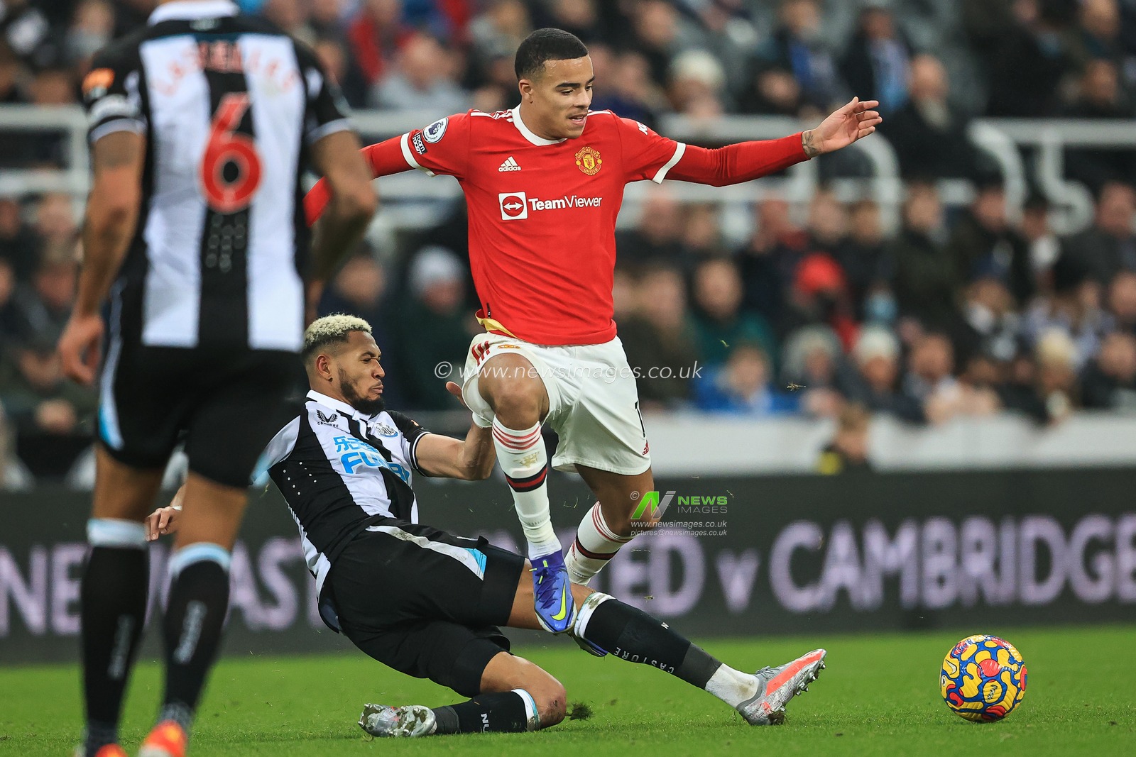 Joe linton #7 of Newcastle United is tackled by Mason Greenwood #11 of Manchester United