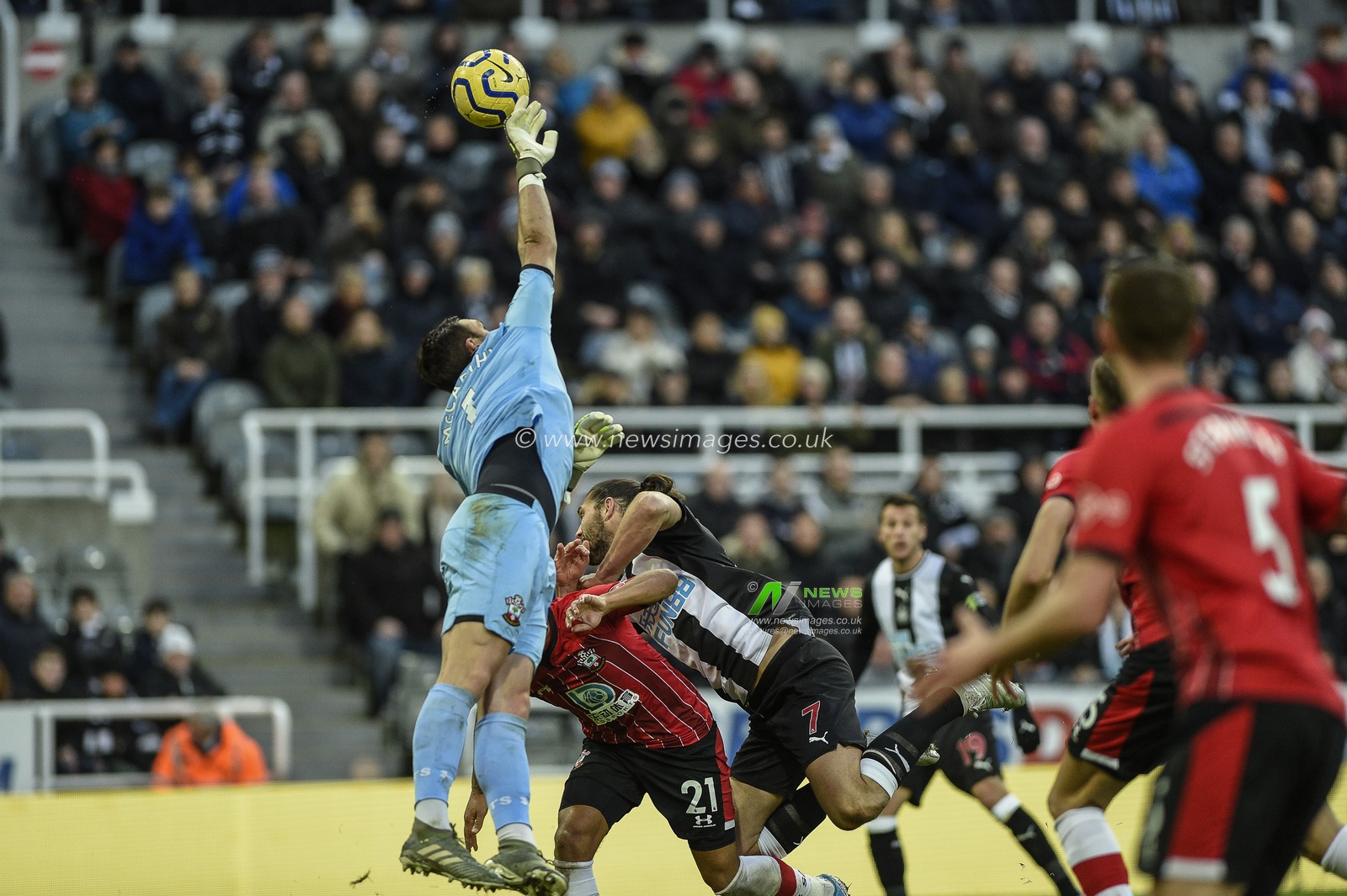 8th December 2019, St. James's Park, Newcastle, England; Premier League, Newcastle United v Southampton : Alex McCarthy (1) of Southampton palms the ball away under pressure from Andy Carroll (7) of Newcastle United

Credit: Iam Burn/News Images