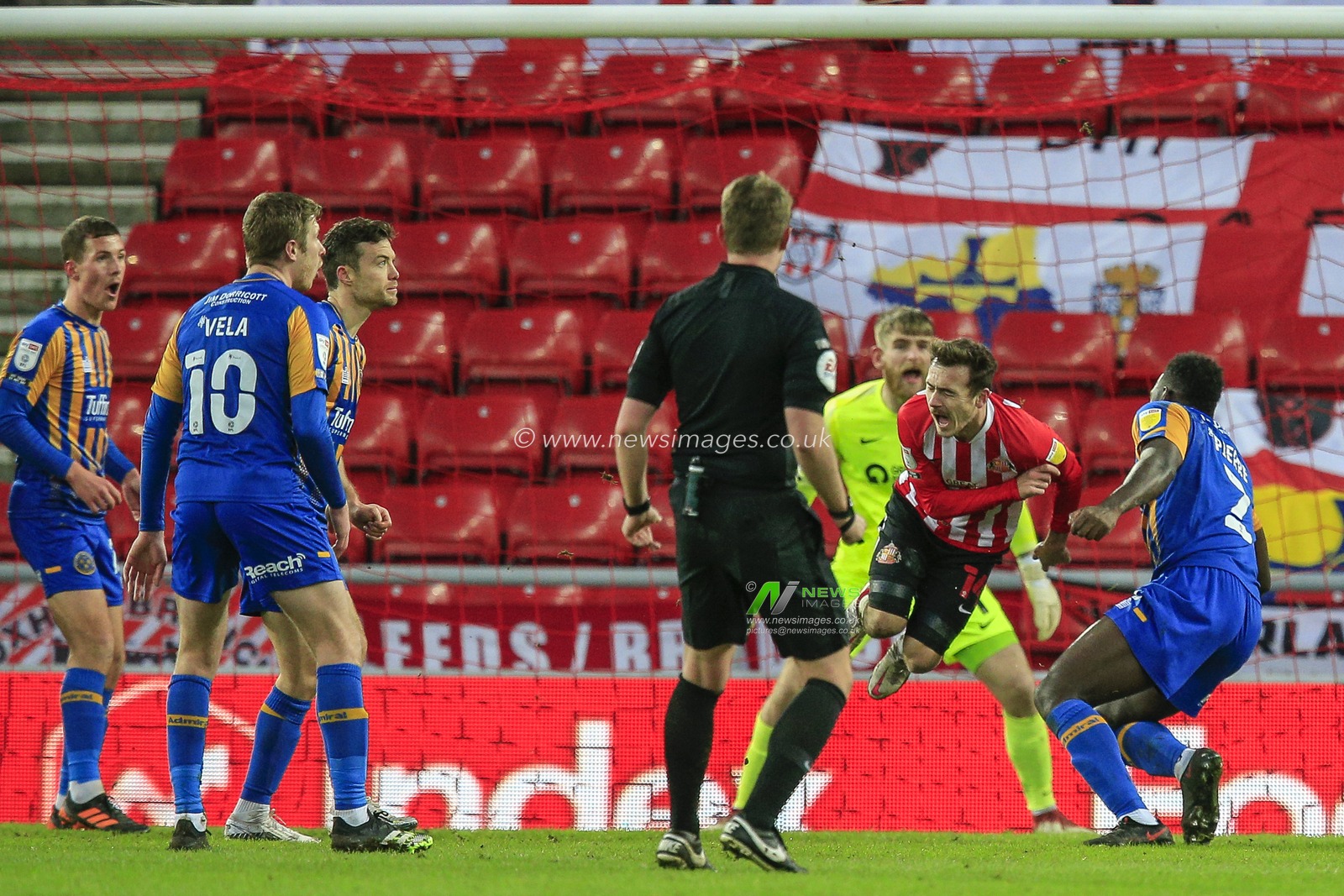Aaron Pierre #2 of Shrewsbury Town fouls Callum McFadzean #25 of Sunderland in the Sunderland penalty area
