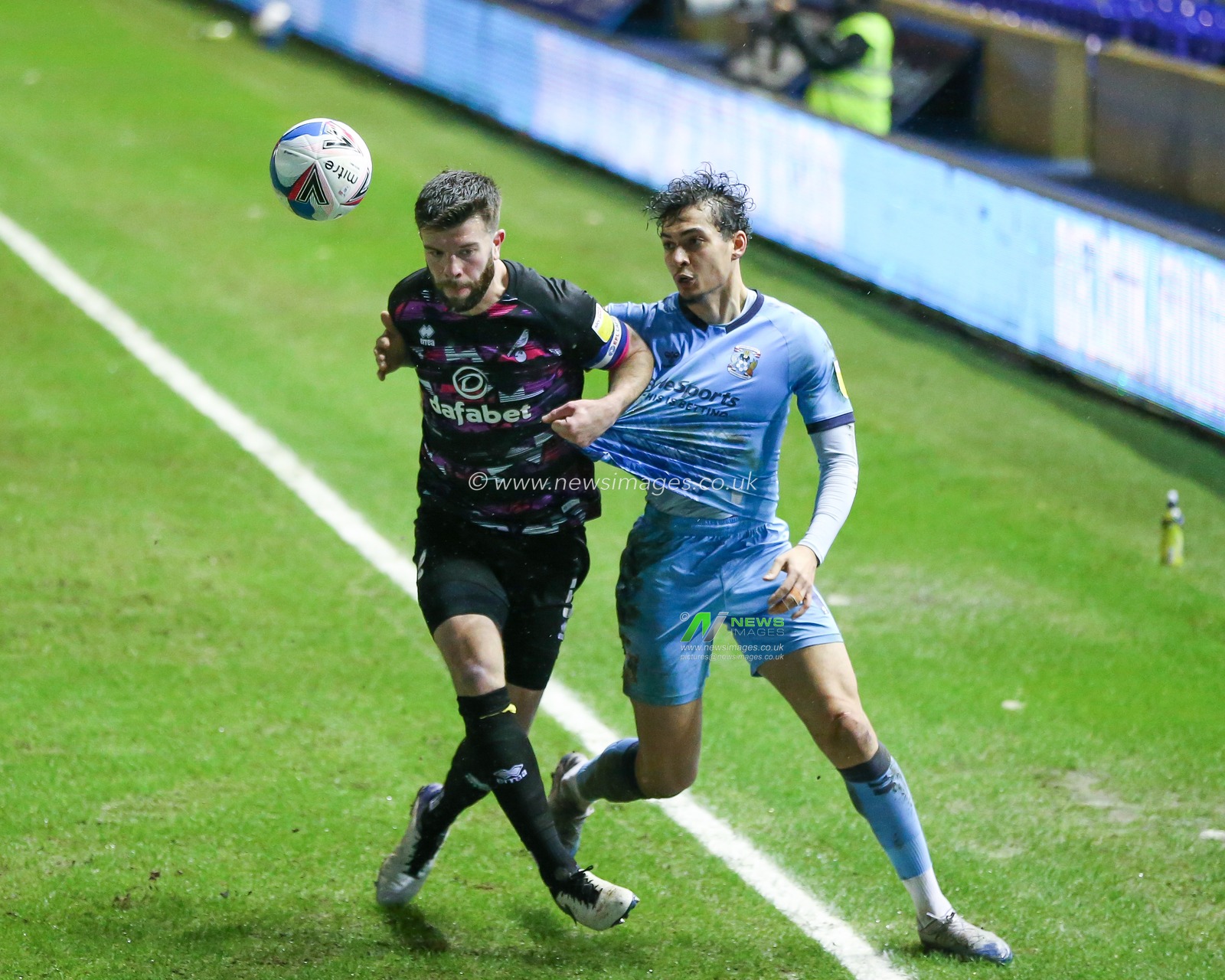 Tyler Walker #19 of Coventry City and Grant Hanley #5 of Norwich City compete for the ball