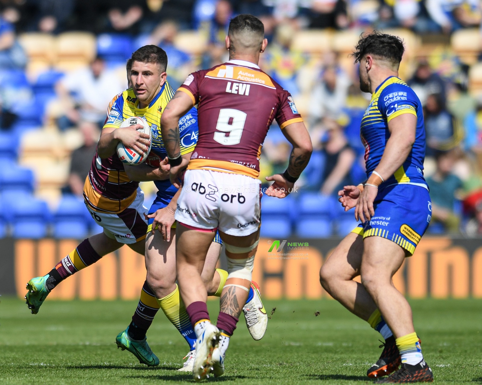 Billy Magoulias #18 of Warrington Wolves runs forward with the ball