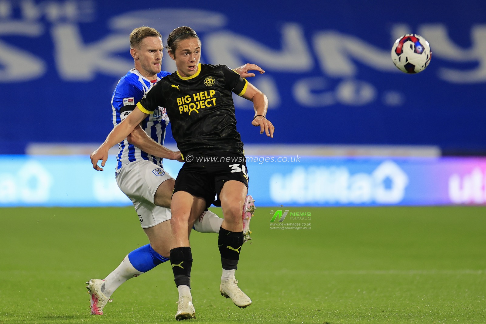 Tom Lees #32 of Huddersfield Town challenges Thelo Aasgaard #30 of Wigan Athleticduring the Sky Bet Championship match Huddersfield Town vs Wigan Athletic at John Smith's Stadium, Huddersfield, United Kingdom, 13th September 2022

(Photo by Conor Molloy/News Images)
