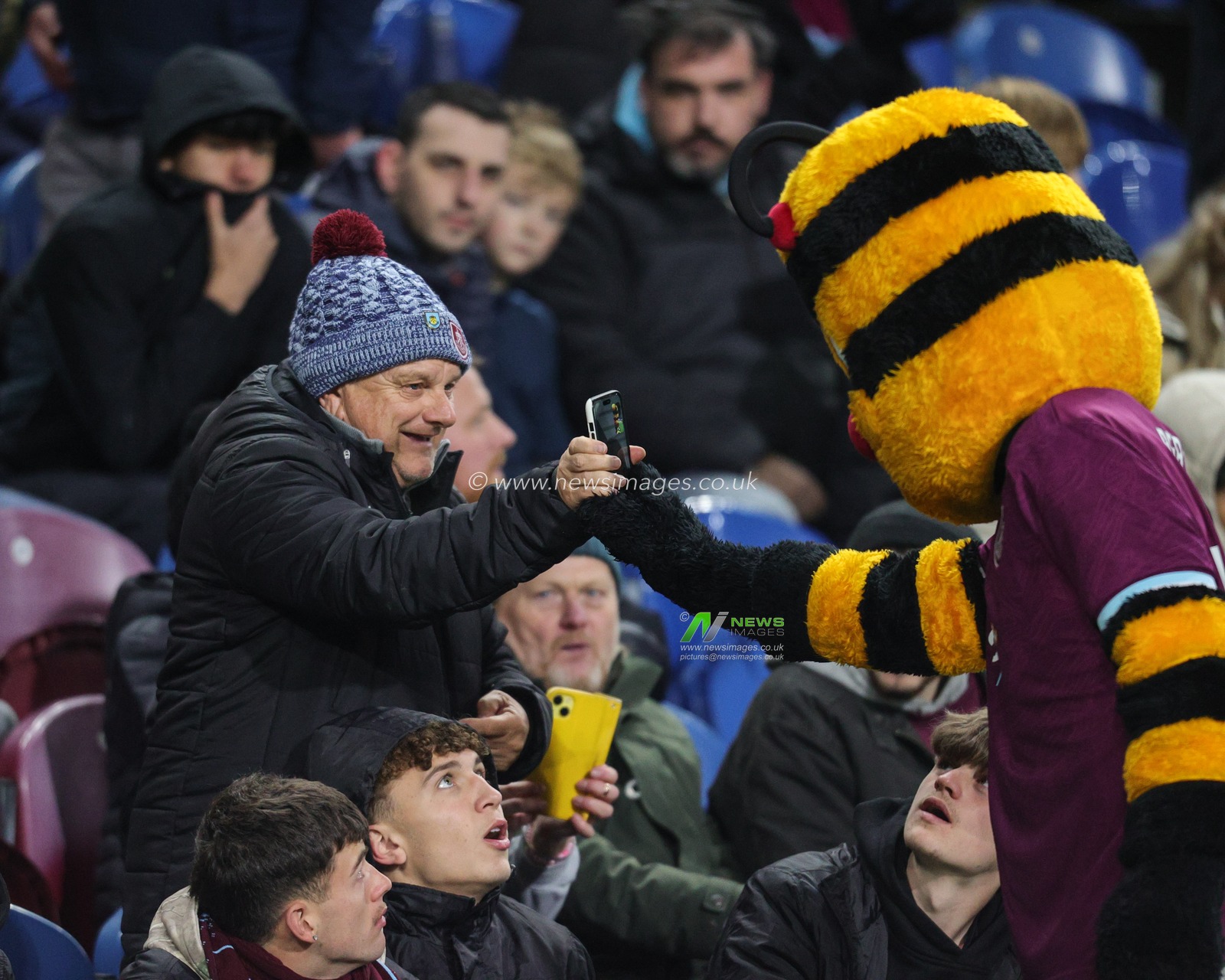 Burnley mascot takes photo with a fan during the Premier League match Burnley vs Crystal Palace at Turf Moor, Burnley, United Kingdom, 3rd December 2025

(Photo by Richard Bierton/News Images)

*** GER AUT SUI OUT ***