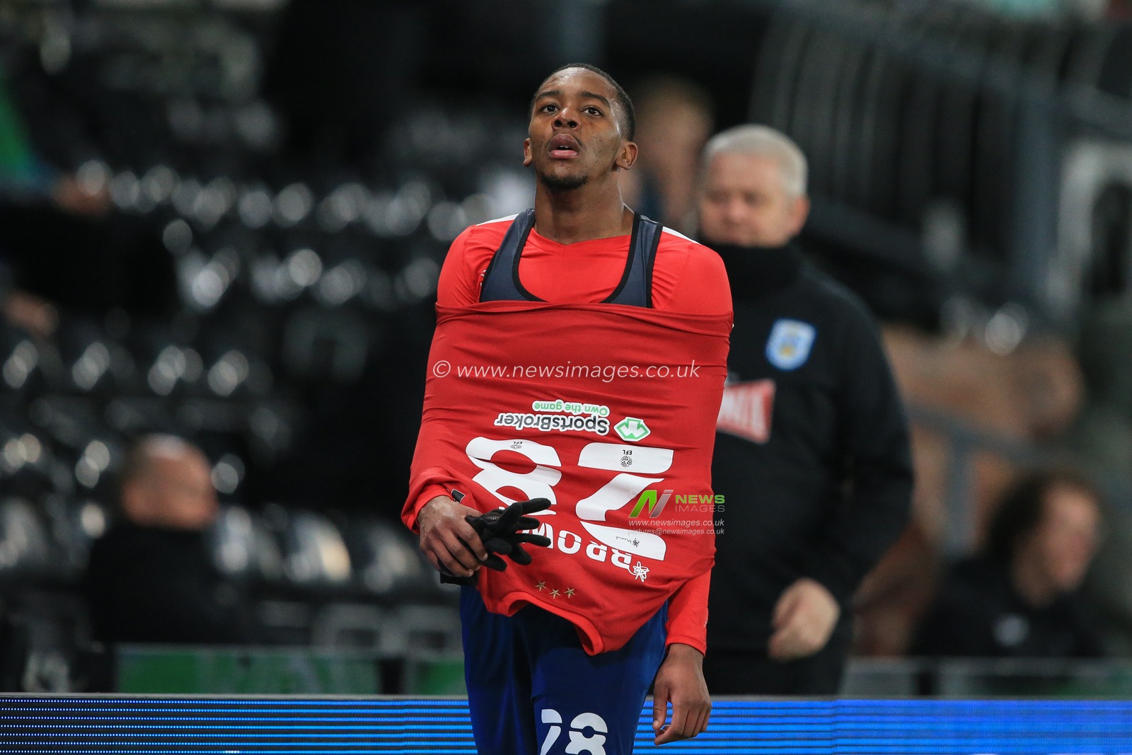 Jaden Brown #28 of Huddersfield Town walks back to the changing rooms after being sent off for two yellow cards followed by a red
