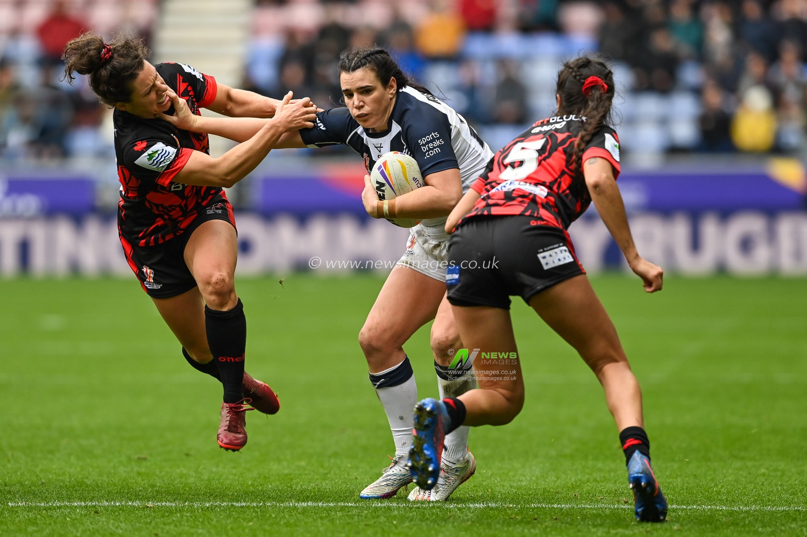 Carrie Roberts of England fends off Gabrielle Hindley of Canada  during the Women's Rugby League World Cup match England Women vs Canada Women at DW Stadium, Wigan, United Kingdom, 5th November 2022

(Photo by Craig Thomas/News Images)