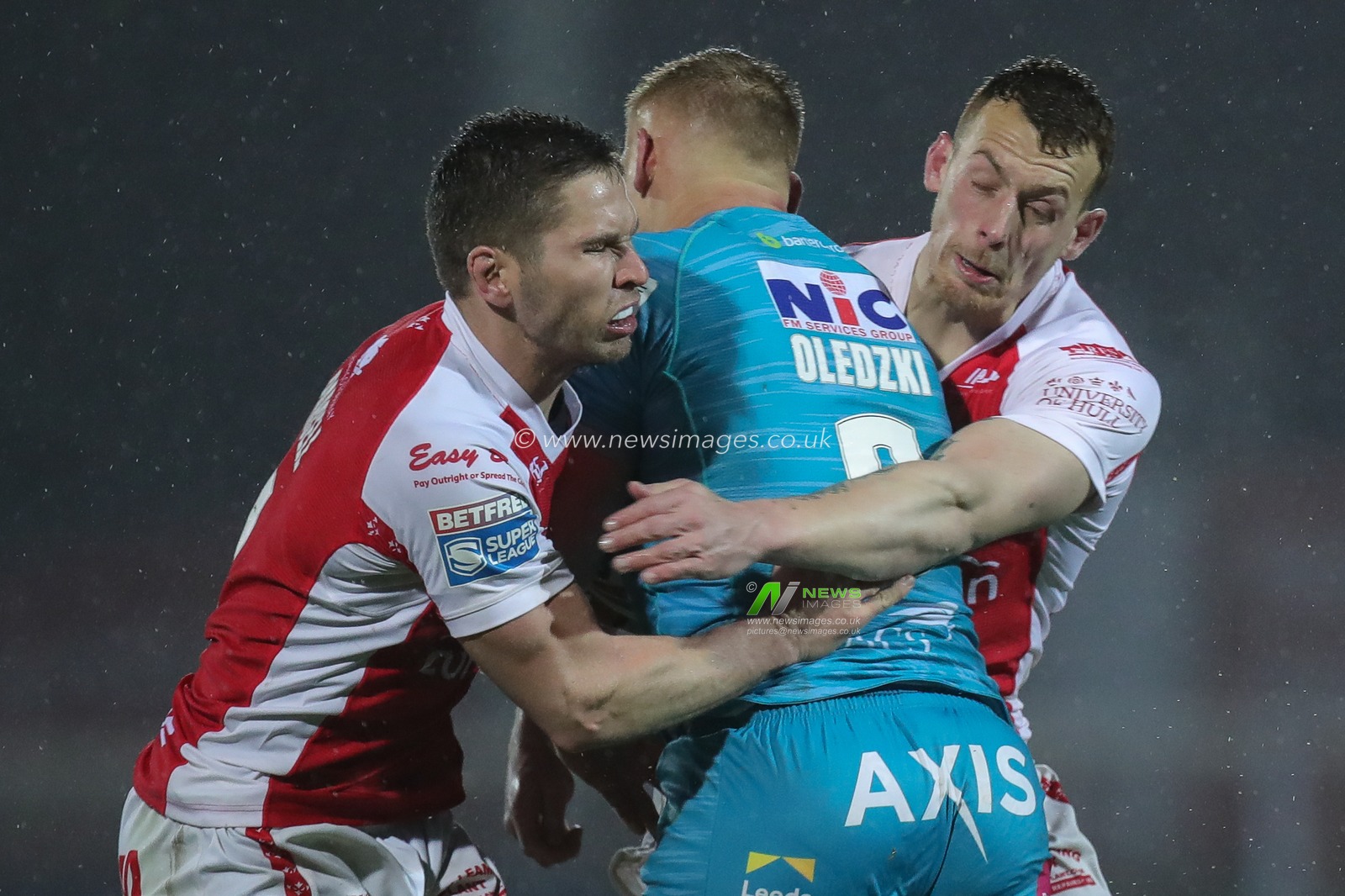 Matt Parcell #9 of Hull KR and Frankie Halton #11 of Hull KR tackle Mikolaj Oledzki #8 of Leeds Rhinos during the Betfred Super League Round 7 match Hull KR vs Leeds Rhinos at Sewell Group Craven Park, Kingston upon Hull, United Kingdom, 31st March 2023

(Photo by James Heaton/News Images)