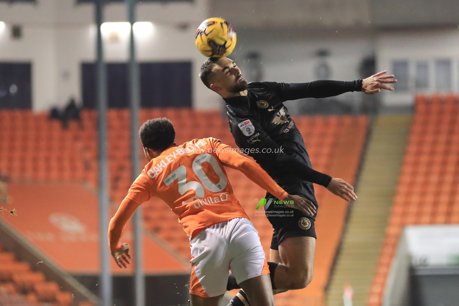 Adam Phillips #30 of Barnsley jumps up to win the high ball during the Bristol Street Motors Trophy match Blackpool vs Barnsley at Bloomfield Road, Blackpool, United Kingdom, 5th December 2023

(Photo by Alfie Cosgrove/News Images)