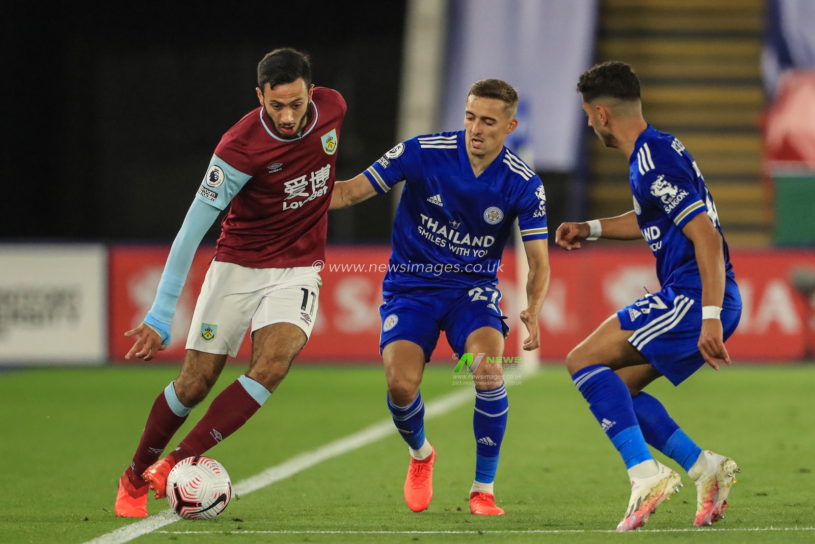 Dwight McNeil (11) of Burnley holds the ball as Timothy Castagne (27) of Leicester City pressures