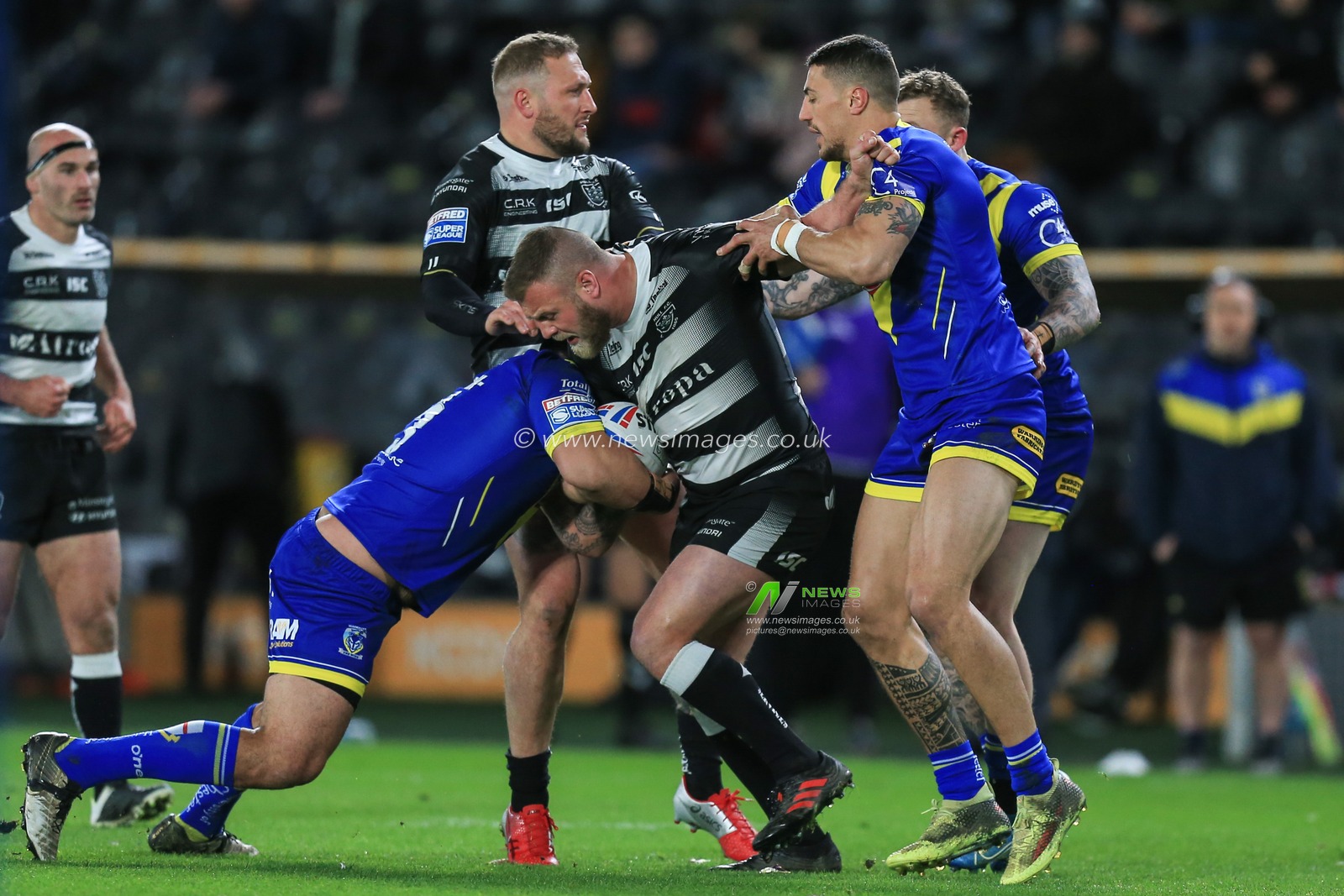 12th March 2020, KCOM Stadium, Hull, England; Betfred Super League, Hull FC v Warrington Wolves : Josh Jones (11) of Hull FC is stopped by the Warrington defence