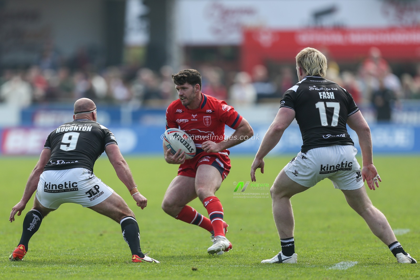 Lachlan Coote #1 of Hull KR looks to go past Danny Houghton #9 of Hull FC