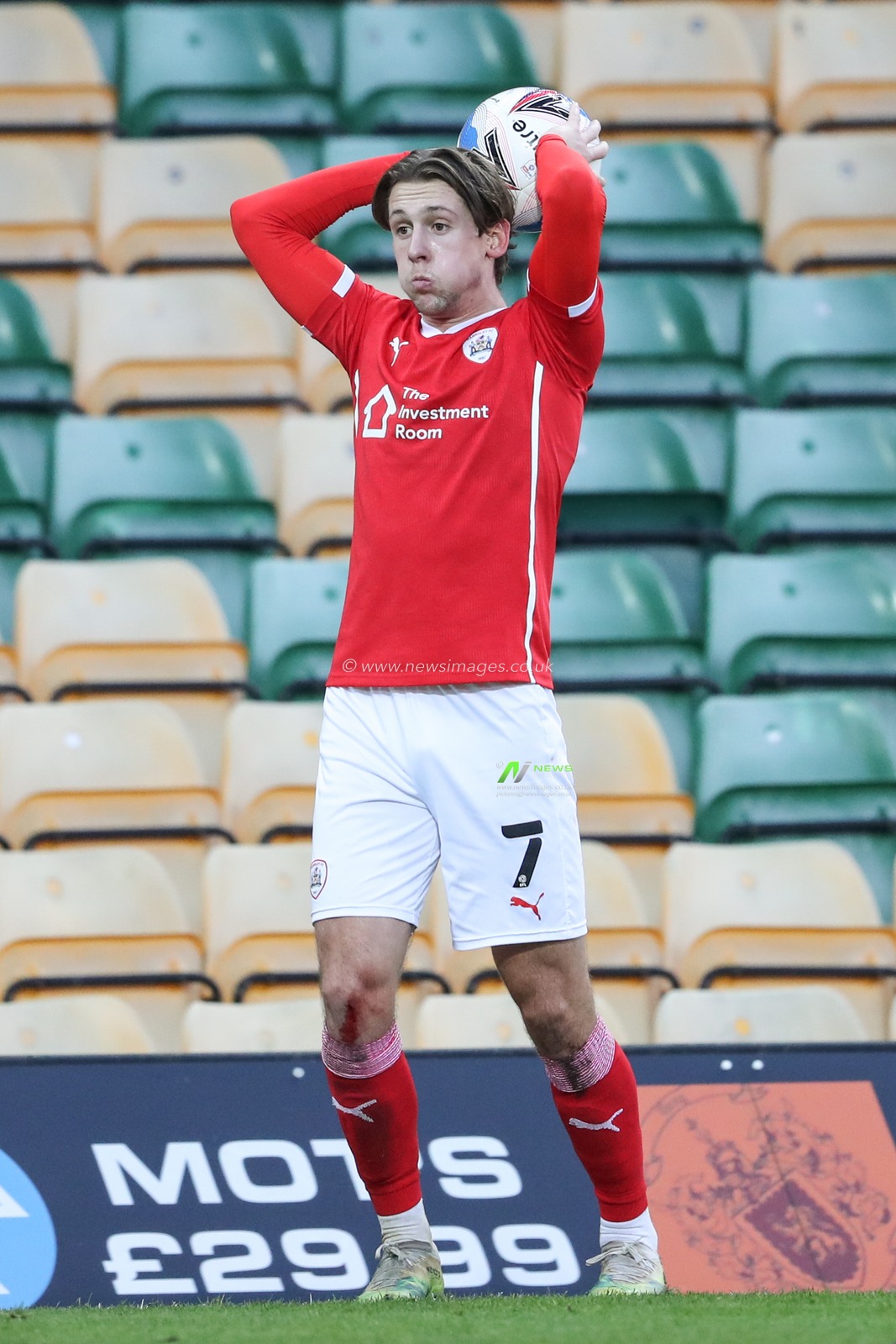 Callum Brittain #7 of Barnsley takes a throw-in