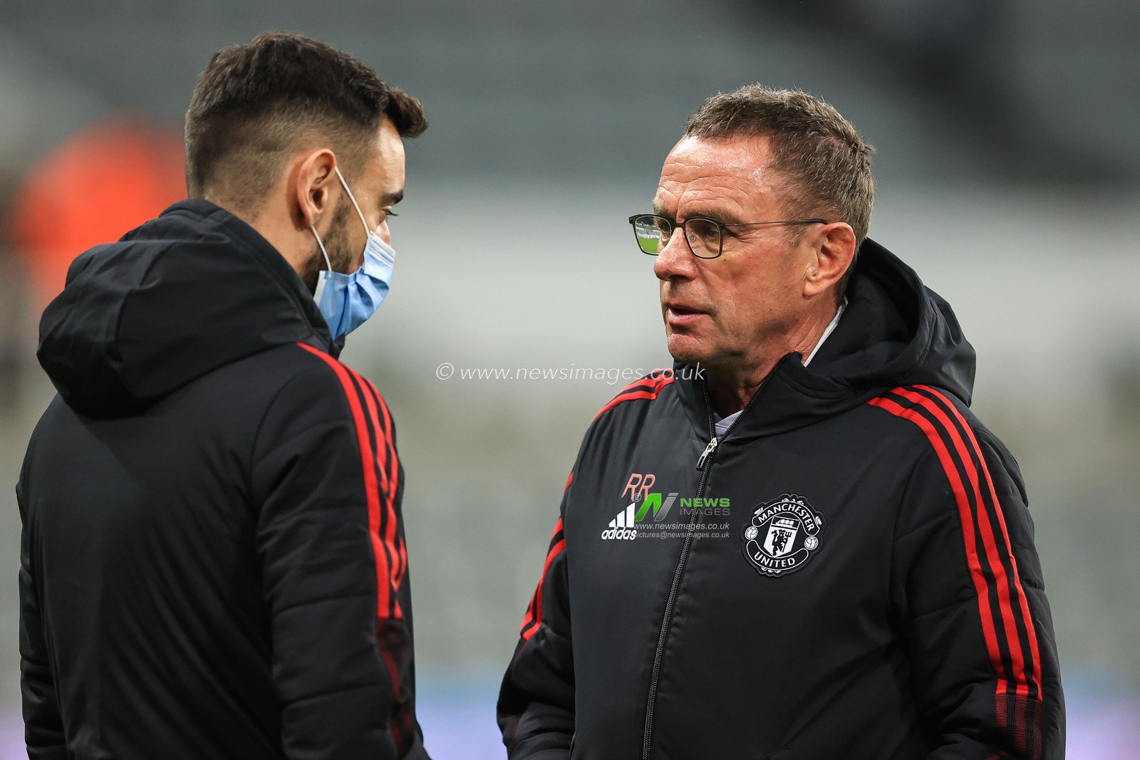 Ralf Rangnick manager of Manchester United speaks to Bruno Fernandes #18 on arrival at St James' Park, Home of Newcastle United