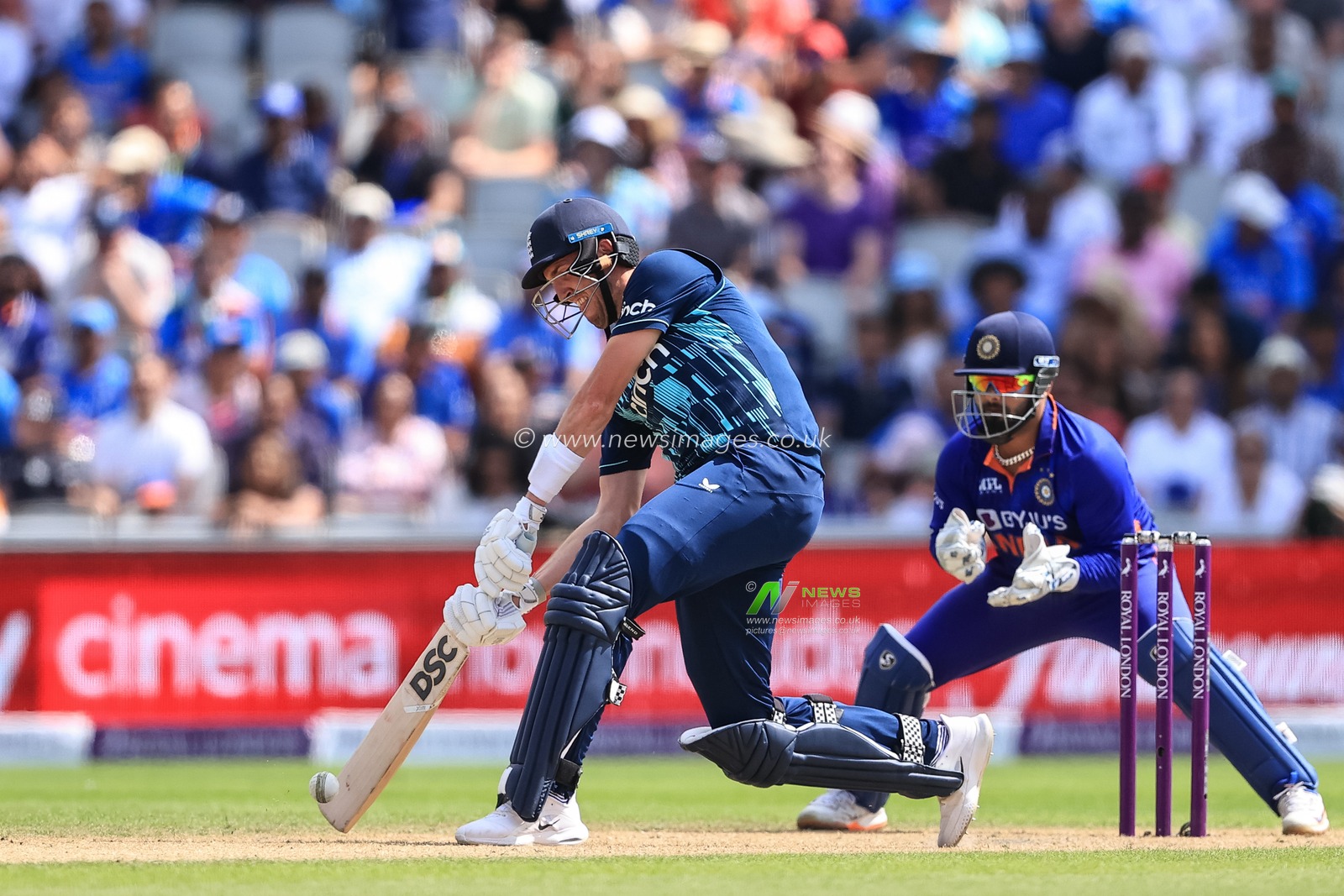 Craig Overton of England hits a six after Mohammed Siraj of India fails to Cath him on the boundary line