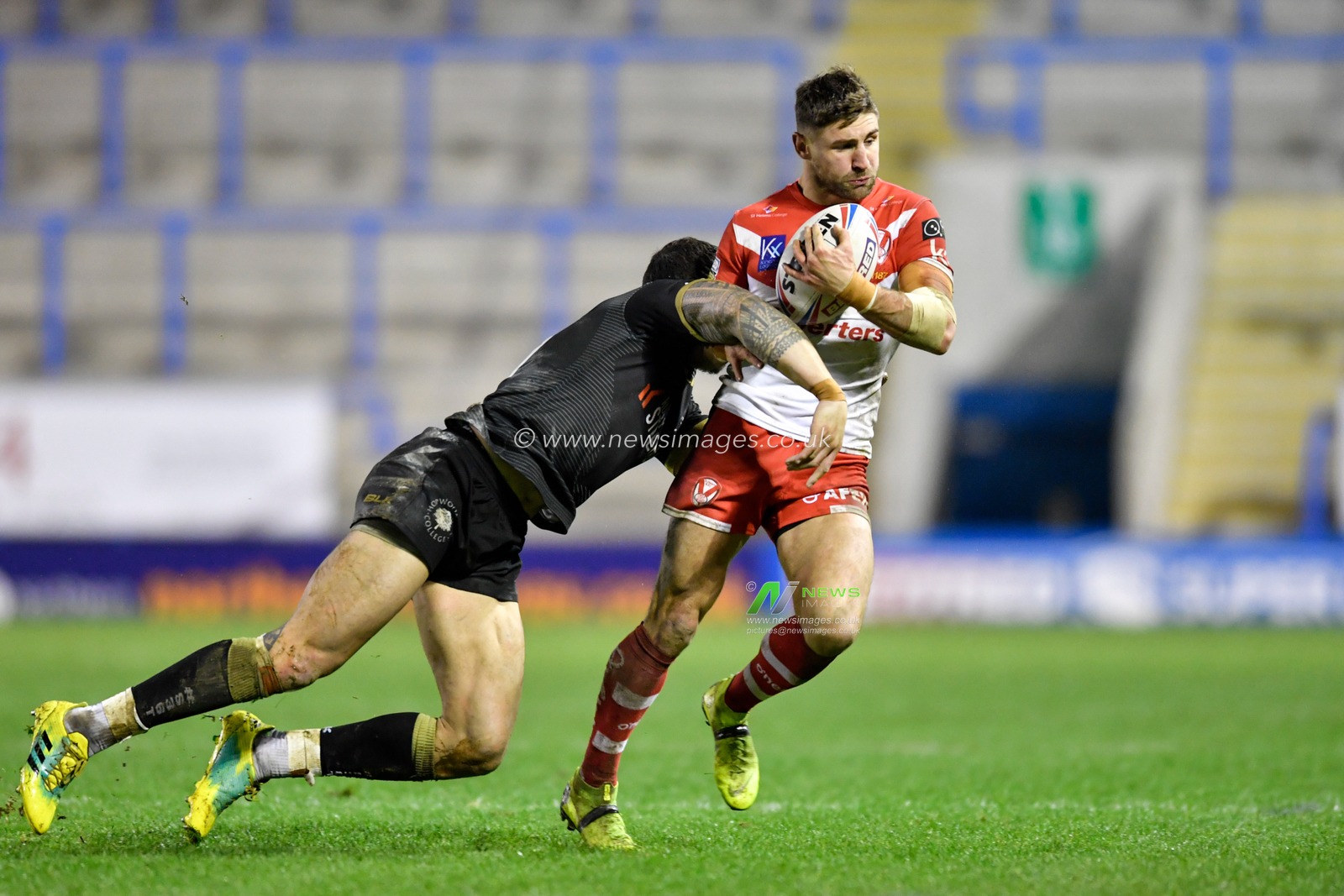 29th February 2020, Halliwell Jones Stadium, Warrington, England; Betfred Super League, Toronto Wolfpack v Saint Helens : Sonny-Bill Williams (21) of Toronto Wolfpack tackles Tommy Makinson (2) of St Helens